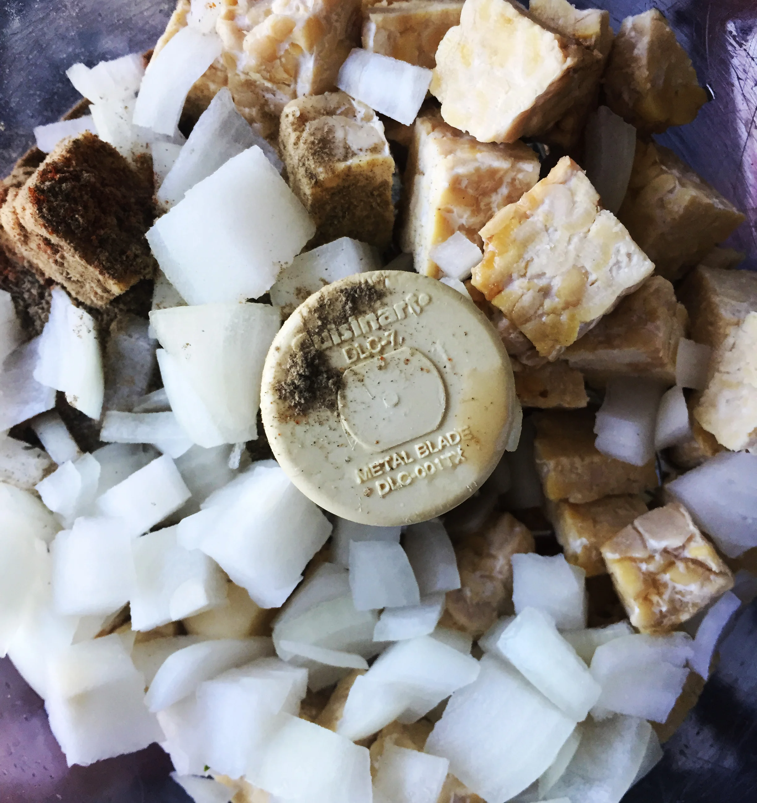 2. While onions cook, add all the sausage ingredients (sans oil) into food processor or blenders. Blend for 10 seconds until well mixed like a ground beef consistency.