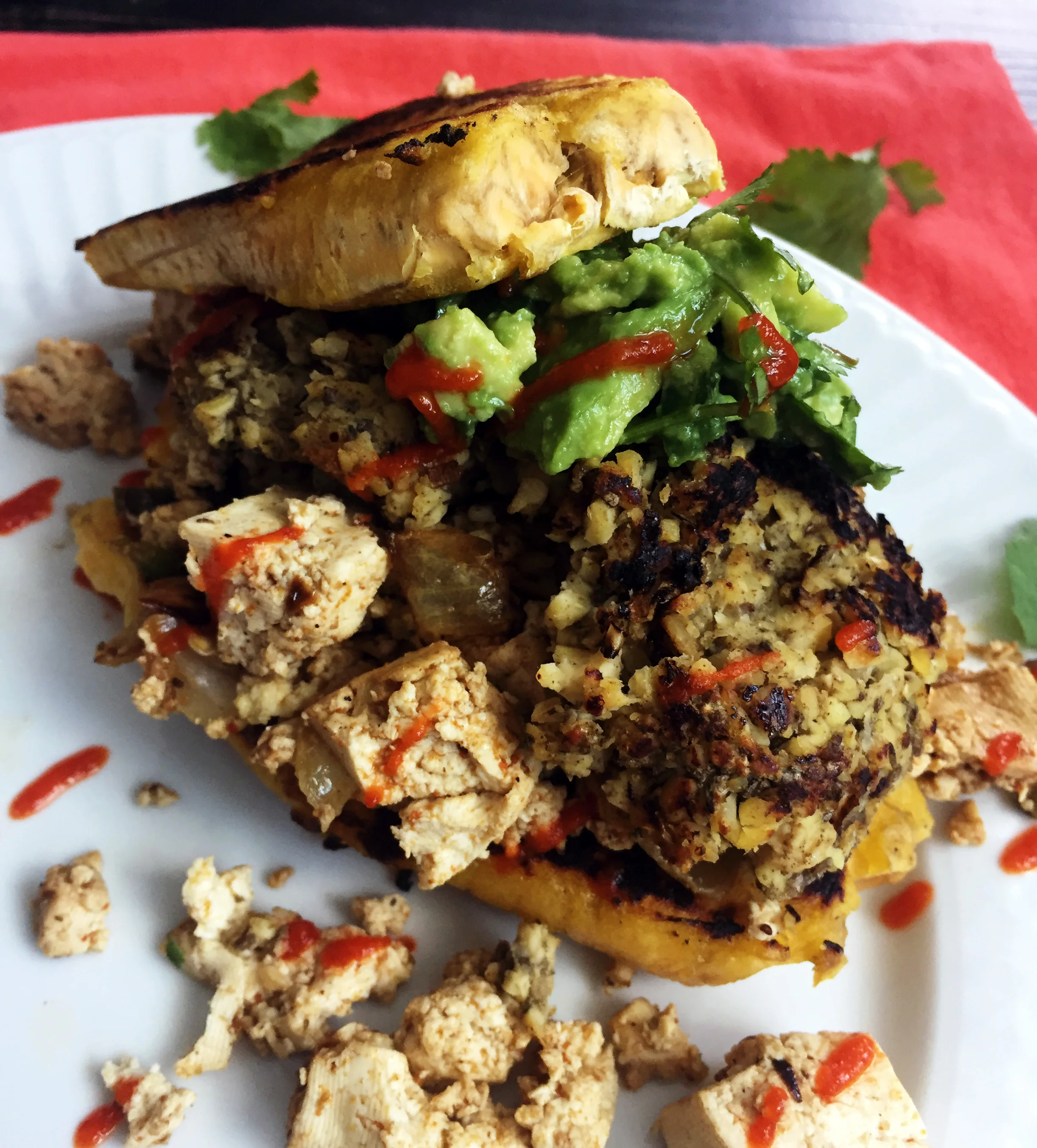 9. At this point, we are done. I form mine with plantain base, heap of tofu scramble, patties, guac, sriracha, and plantain! Enjoy!