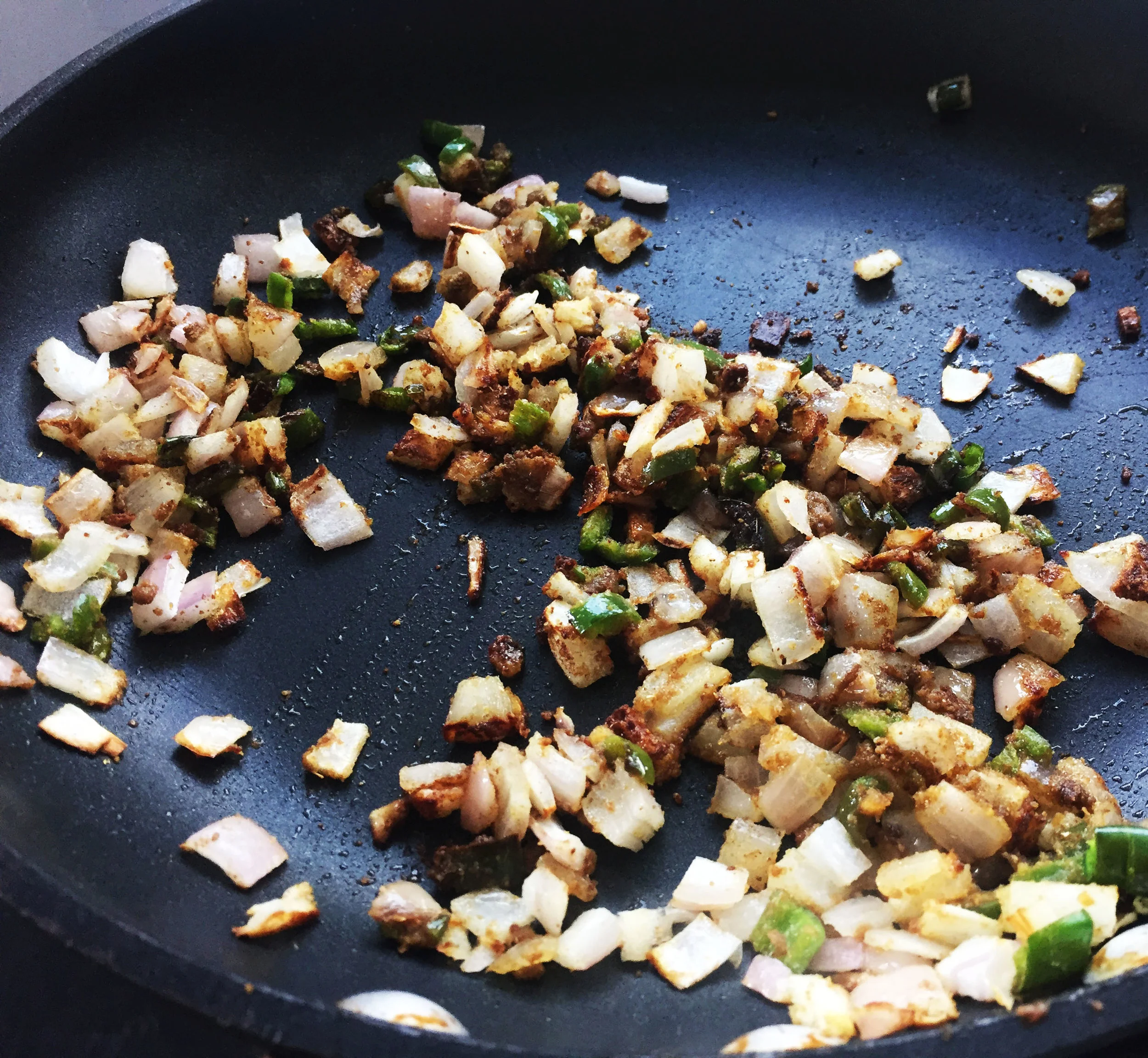 2. While squash bakes, chop up the onions and peppers for the cheese. Saute on pan for few minutes then add spices from cumin to onion powder in ingredients. Continue to saute for another 5-6 minutes until a dry paste starts to form. Set aside.