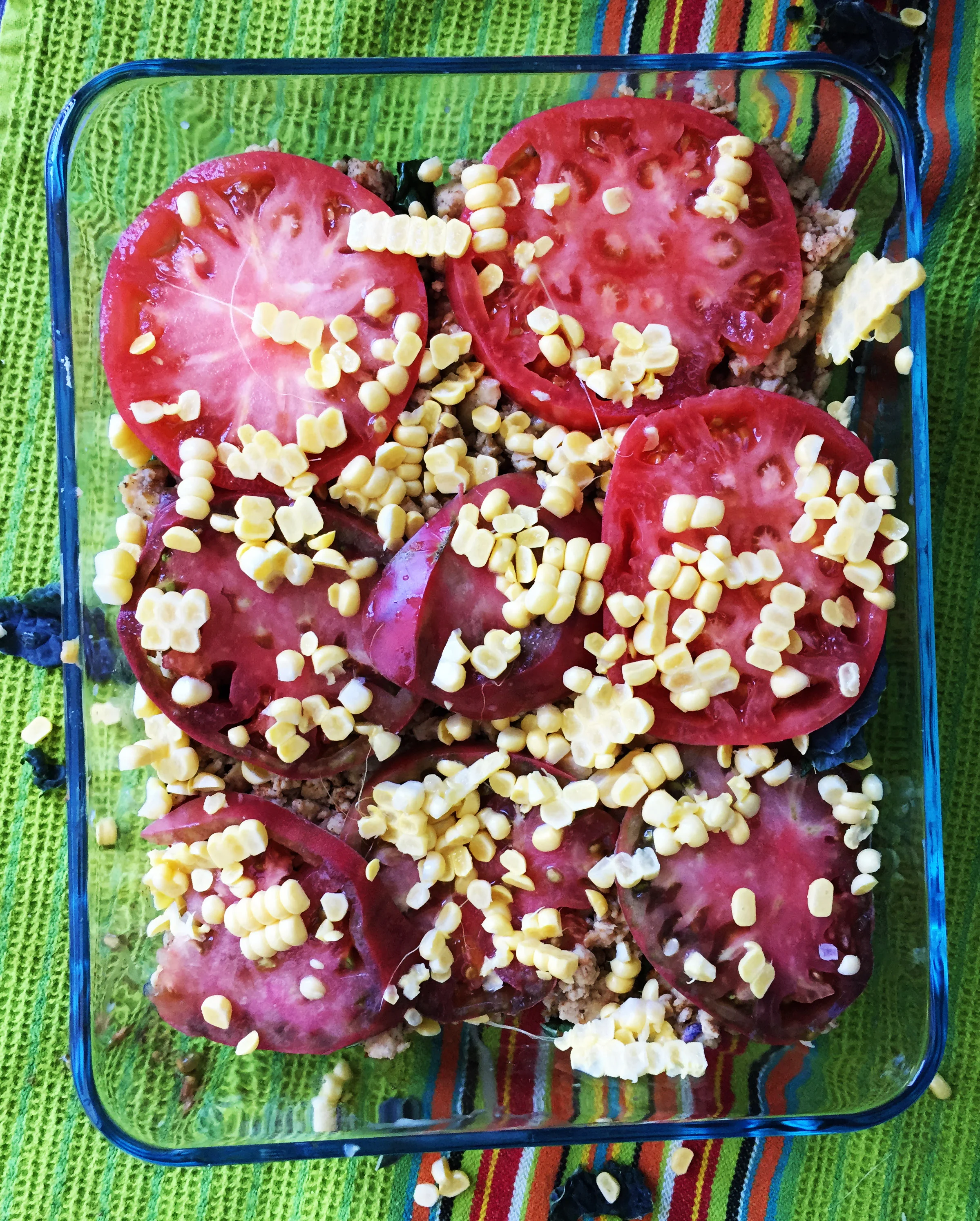 8. Finish the casserole with a layer of tomato slices and fresh corn. Place in the oven and bake for 10 minutes.