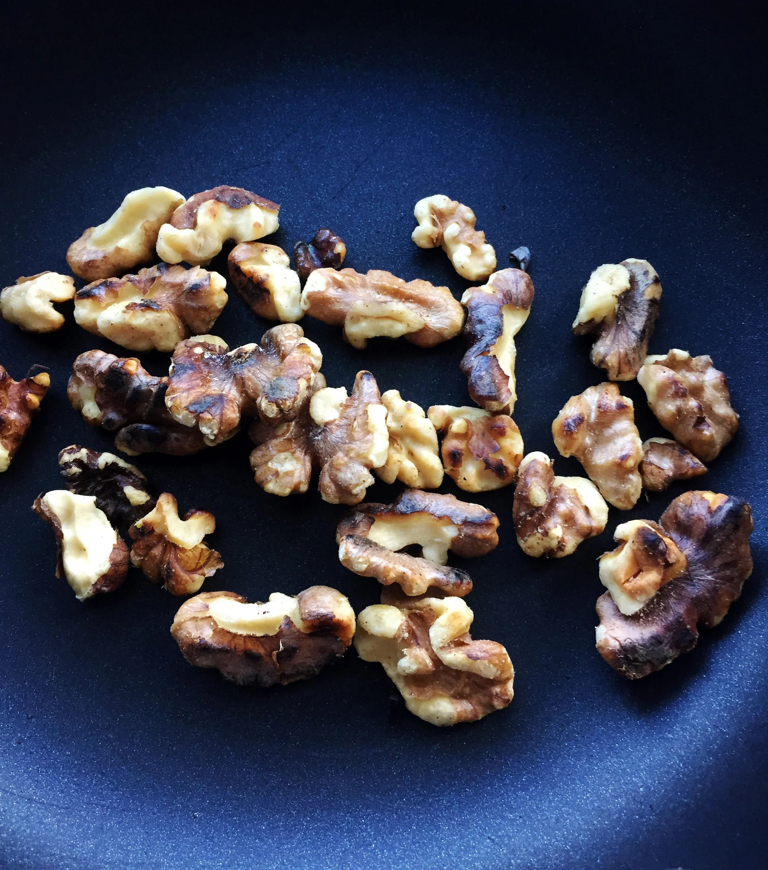 1. Place walnuts in a small pan over medium heat and toast on each side for a few minutes.