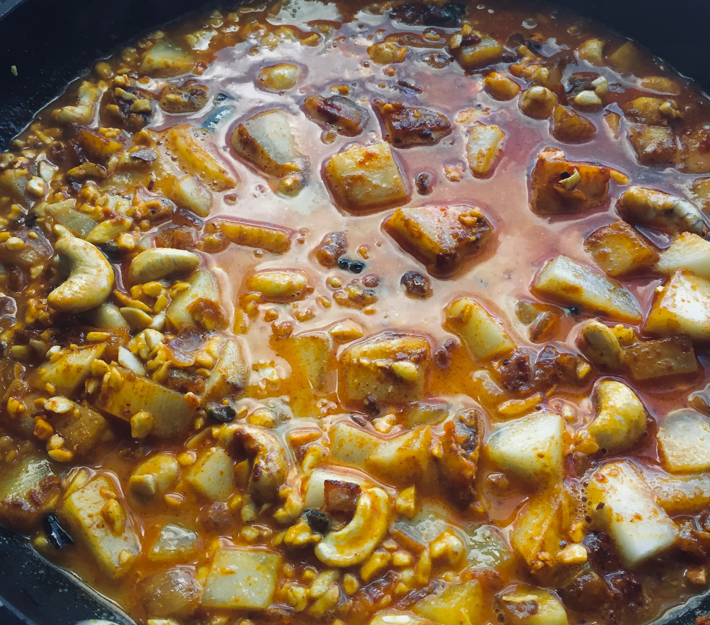 3. For the queso, next add the potatoes and cashews into the pan as well as milk and water. Coat well and bring to a boil. Reduce to a low simmer and cook for 8 minutes.