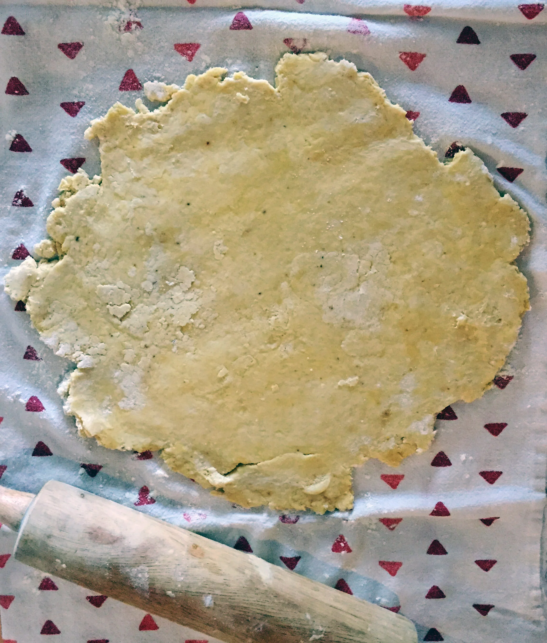 4. Place the dough ball on a tea towel that is sprinkled with flour. Sprinkle some more flour on top of the ball. Rub some flour on your rolling pin and then roll out until the dough until the diameter is larger than the pie pan. Place the pan on top of the dough and flip it so the sough falls into the pan.