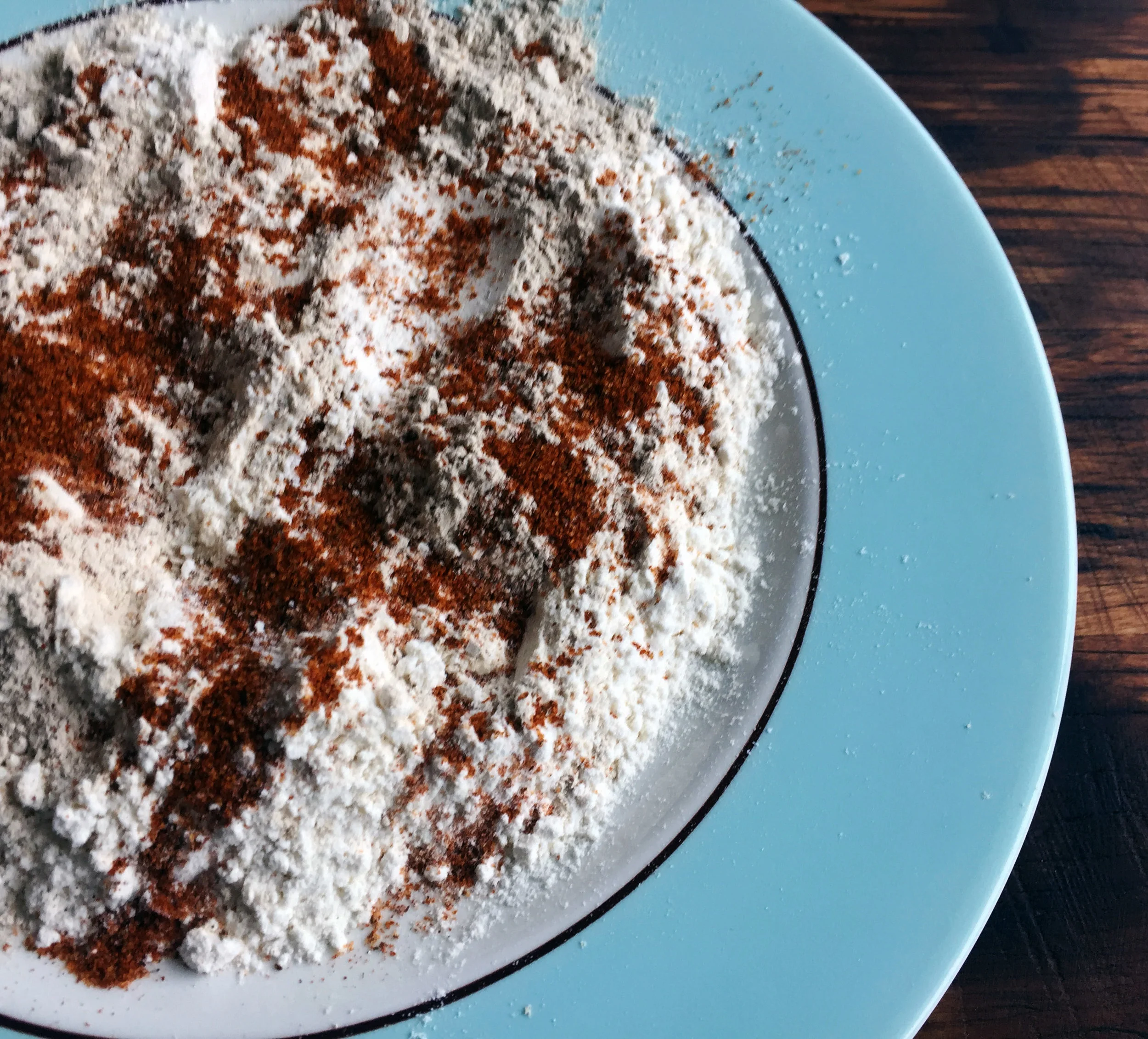 2. Next mix flour with garlic powder on a plate and set aside.