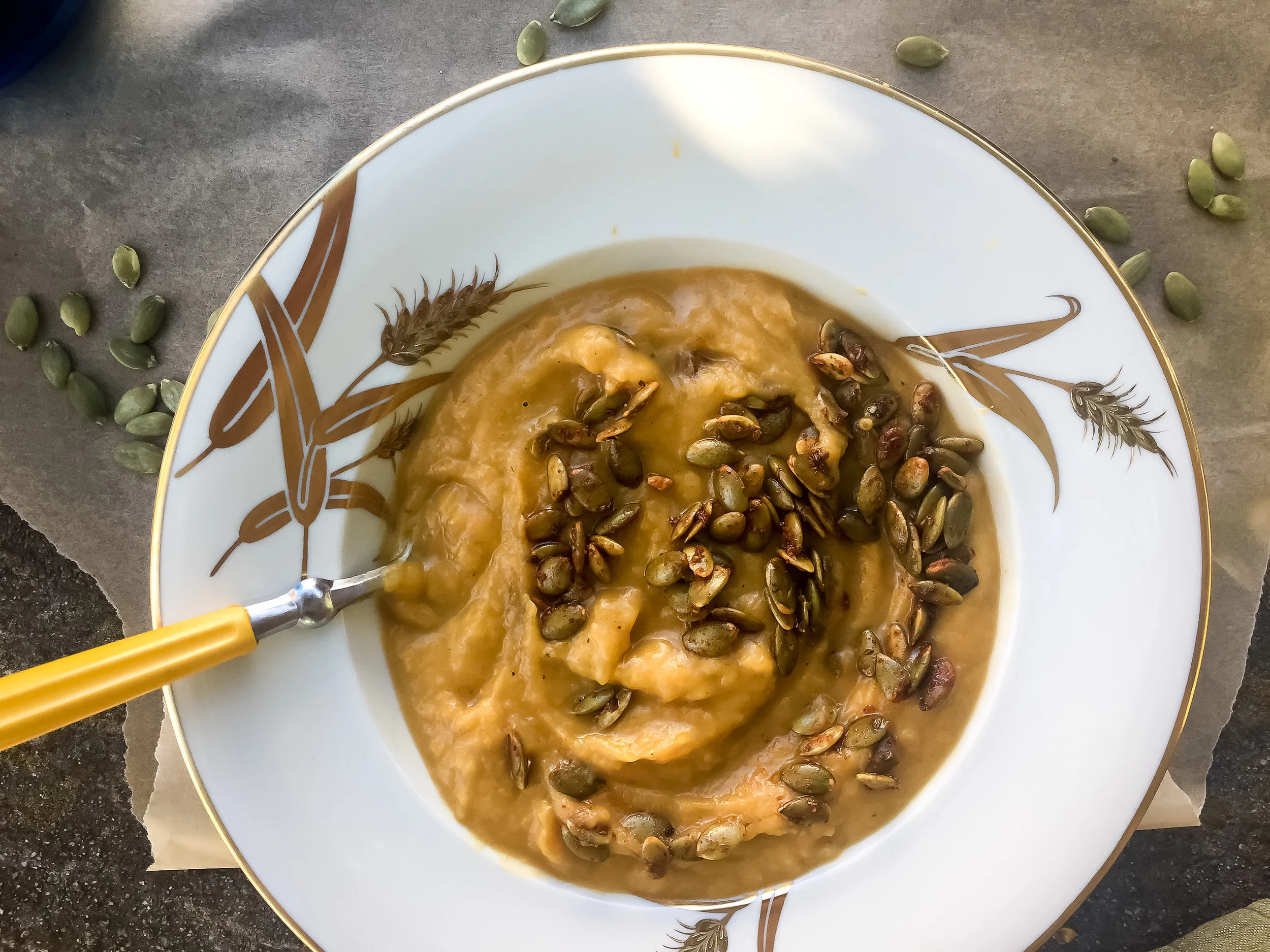 3. To complete the soup, use a stick blender to blend the soup in the slow cooker. You can also scoop out portions and blend in an upright blender. Blend until smooth throughout the soup. It took me a couple minutes to really get it smooth with my hand blender. Serve with a handful of pepitas and enjoy!