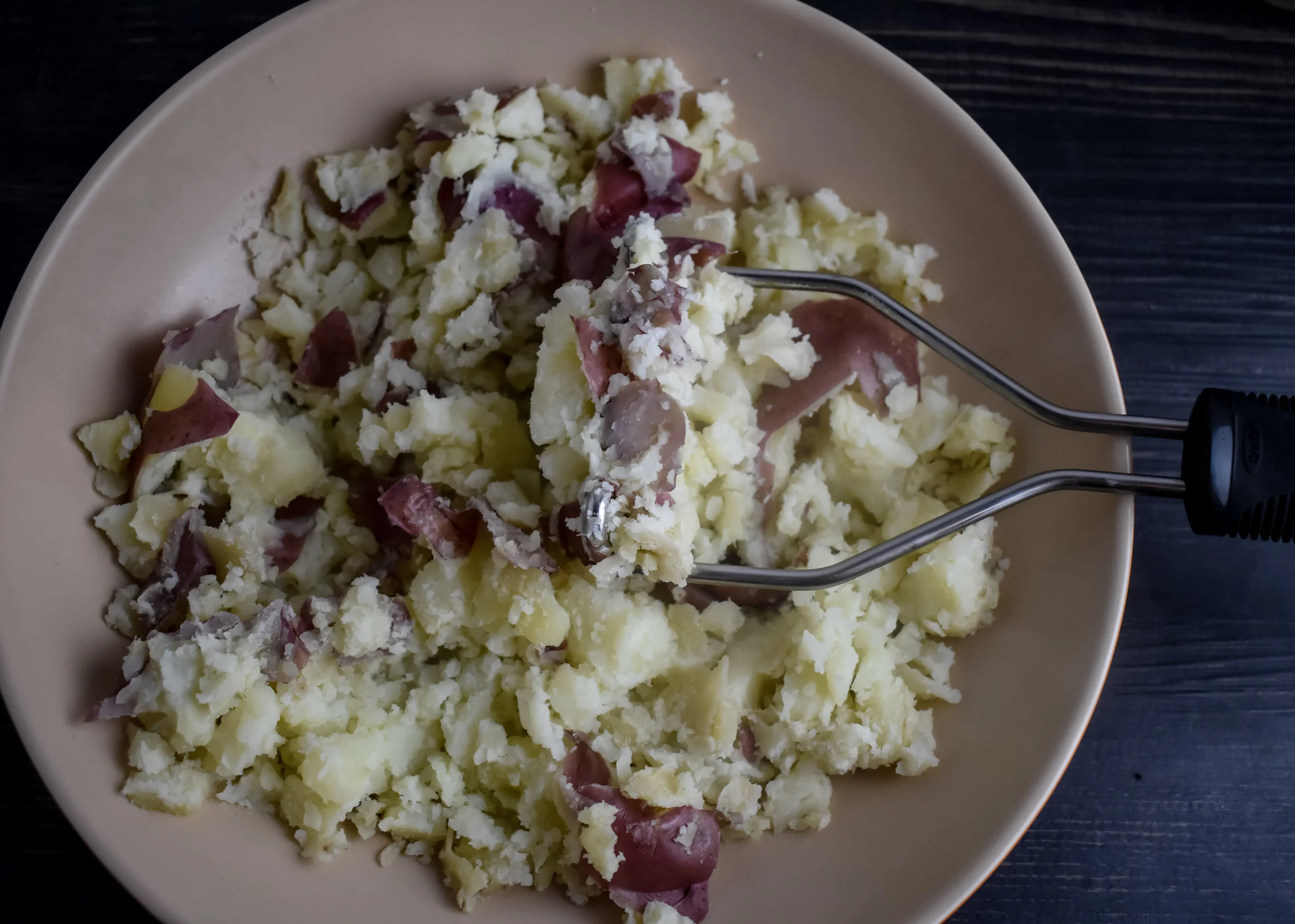 1. 2. Place new potatoes in large pot, cover with water, and bring to boil. Boil for 20-25 minutes until tender. A knife should go through the potato with no tension. Once done, mash with a potato smasher or large knife.