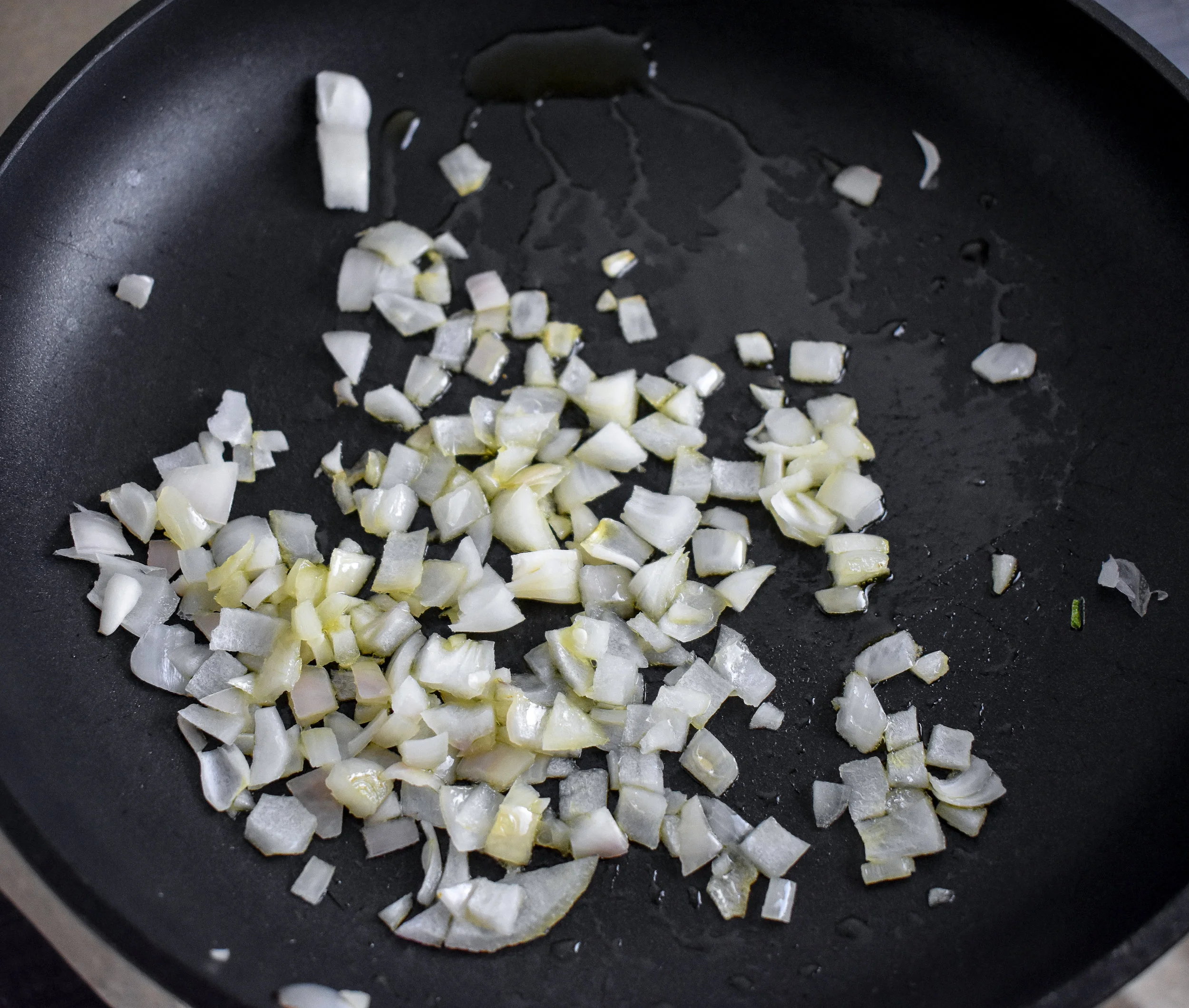 3. While the potatoes are cooking, place onions in a large frying pan with 1 tbl of oil. Cook over medium heat for 5-6 minutes. Turn off if potatoes are not done. If they are done, add potatoes/sunchokes.