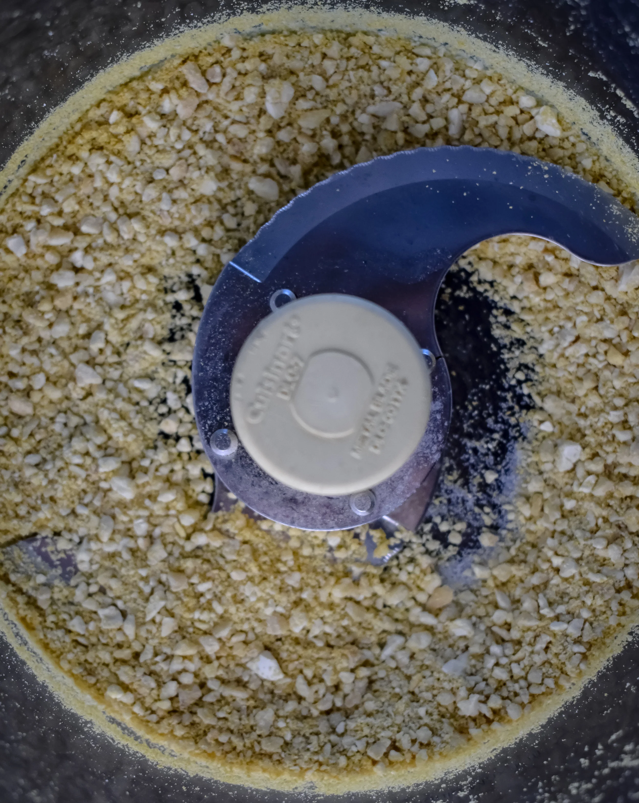 2. While the onions and garlic are cooking, blend together in high-speed blender or food processor the cashews, nutritional yeast, garlic powder, and salt. This will act as a parmesan cheese.