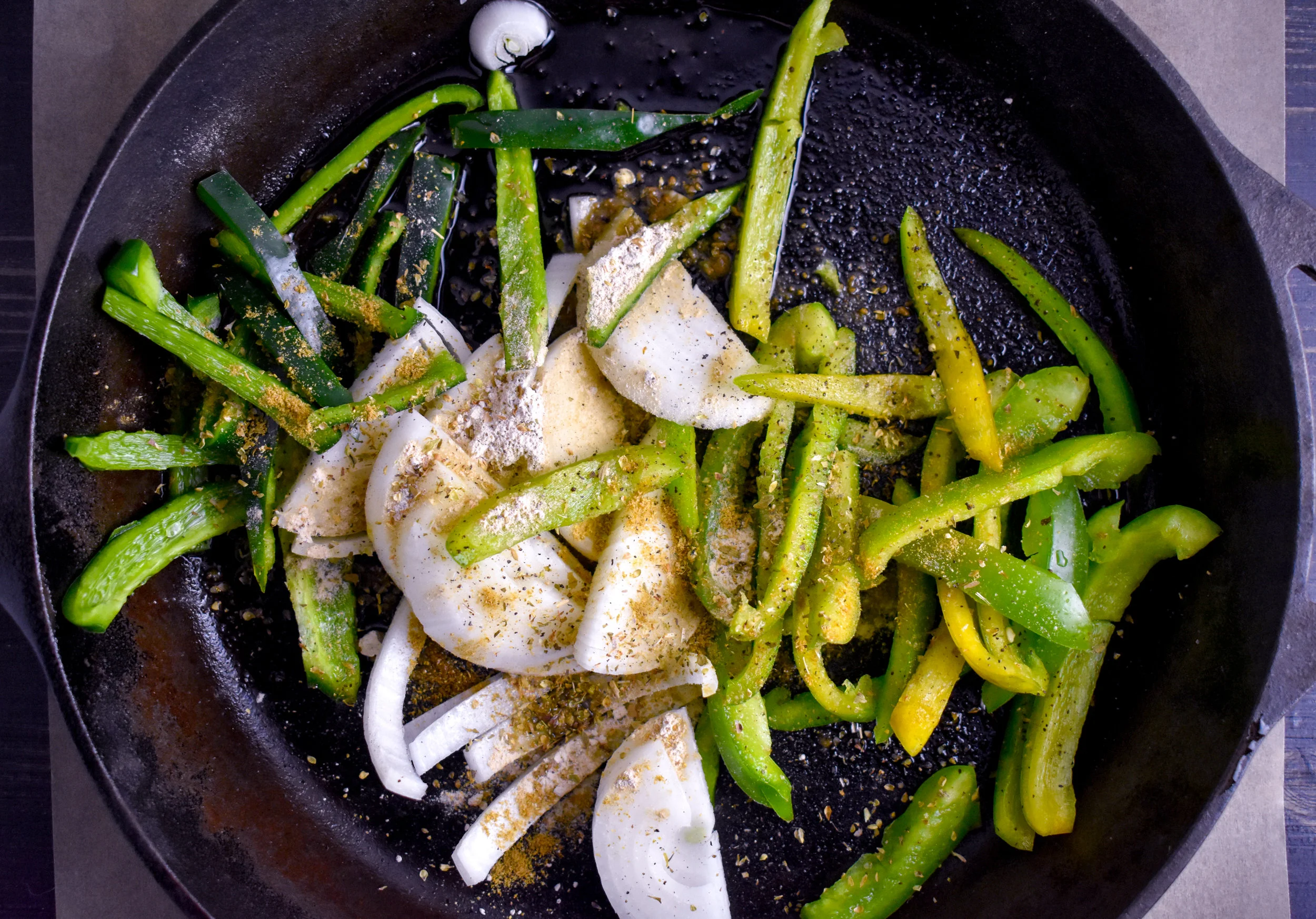 1. To start, put 1.5 tbl vegan butter in castiron pan. Heat for 90 seconds over medium heat. Place peppers and onions. Cook for 2 minutes then add all spices. Cook 2 more minutes then reduce to low heat and continue to cook for the entire recipe.