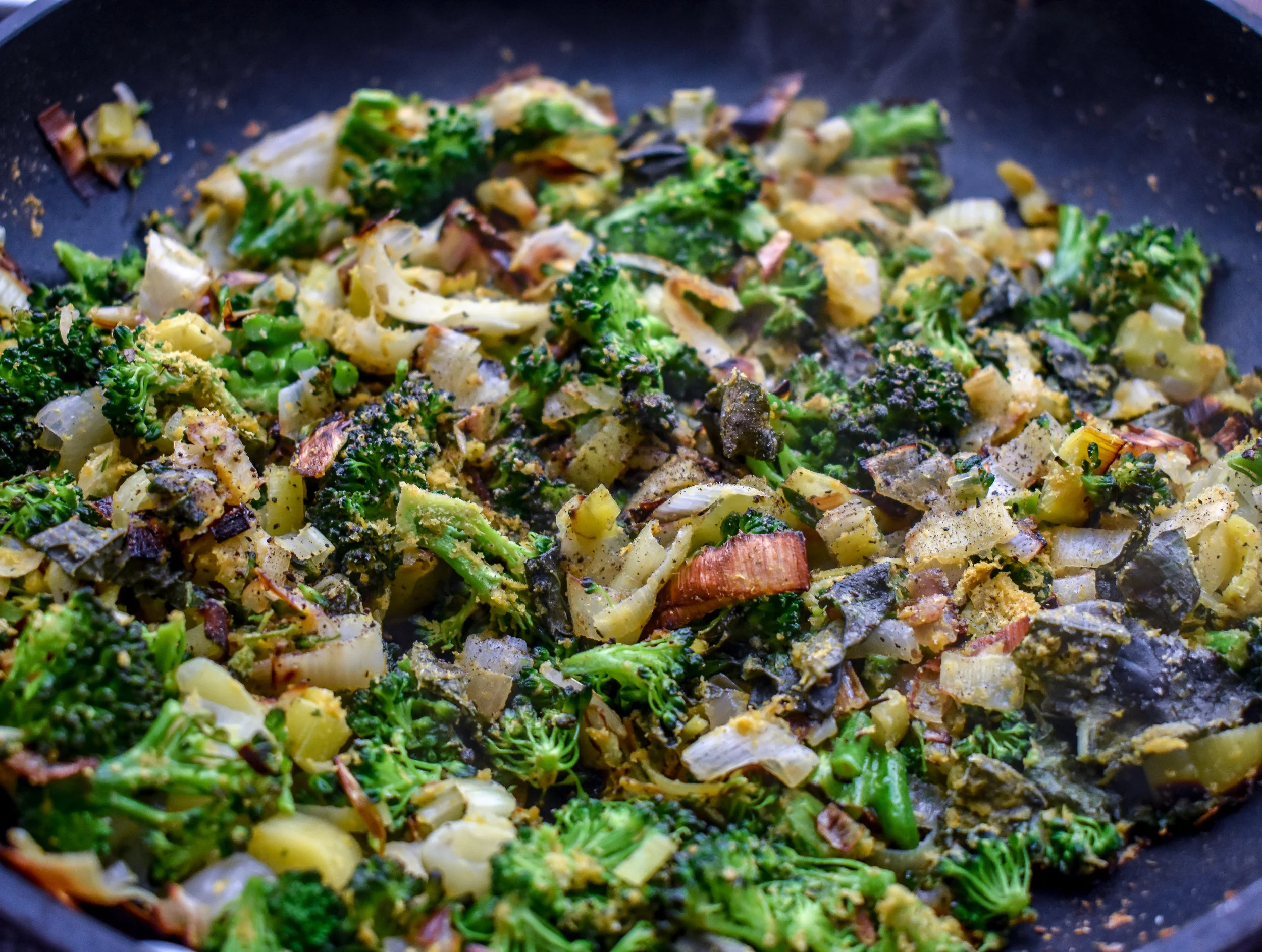 7. Place leeks + shallots in a large frying pan with tbl of olive oil. Cook for 4-5 minutes on medium heat then add in broccoli and spices. Cook for another 2-3 minutes until broccoli florets start to wilt.