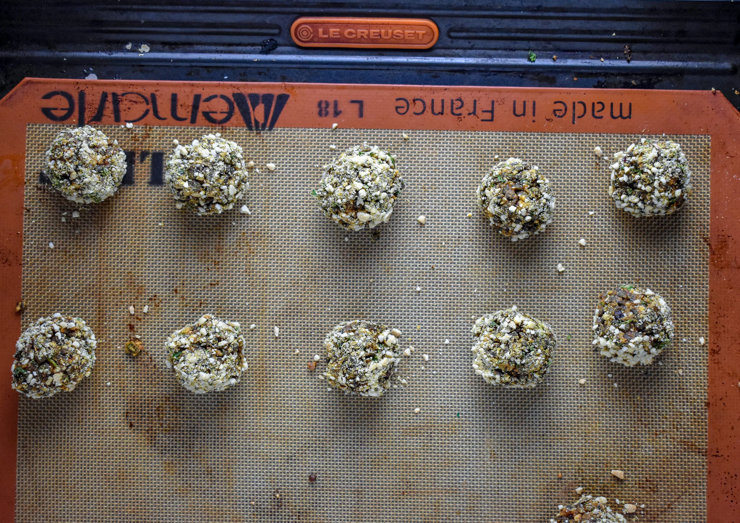 6. Roll the mixture into 10 balls, then roll each ball into the 1/4 cup parm mixture (you'll have 3/4 cup leftover for the spaghetti). Place into the oven at 350F and cook for 18 minutes until browned on the edges.