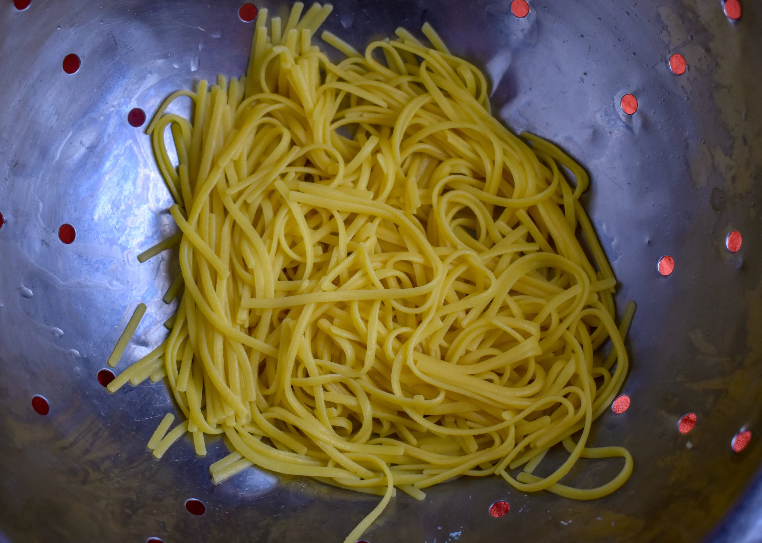 7. While the meatballs cook, add the spaghetti to boiling water and cook for 8 minutes. Drain. Set aside.
