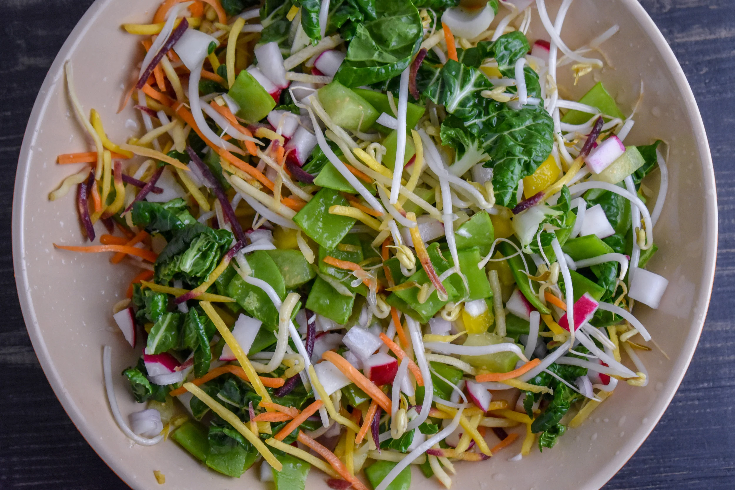 2. While the potatoes + tofu cook, mix all of your veggies into a large mixing bowl with lime juice and spices. Set aside.