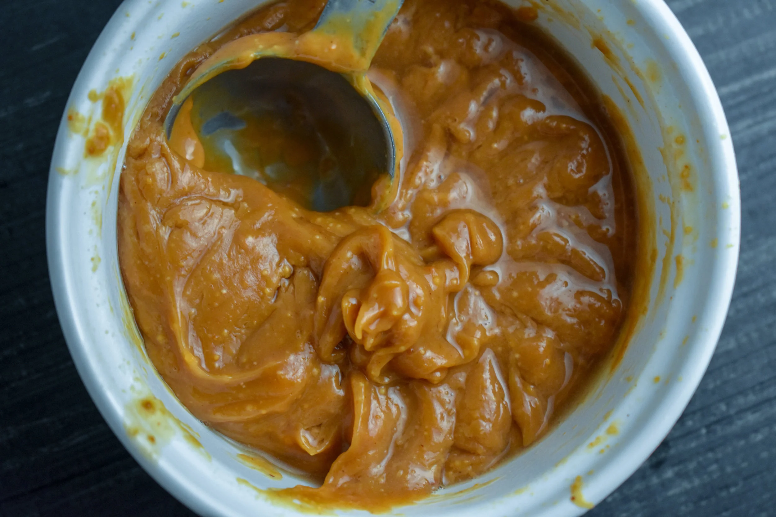 4. While those veggies are cooking, whisk together the peanut sauce. Add all ingredients to a small mixing bowl and whisk. It will be fairly thick but thinner than normal peanut butter.