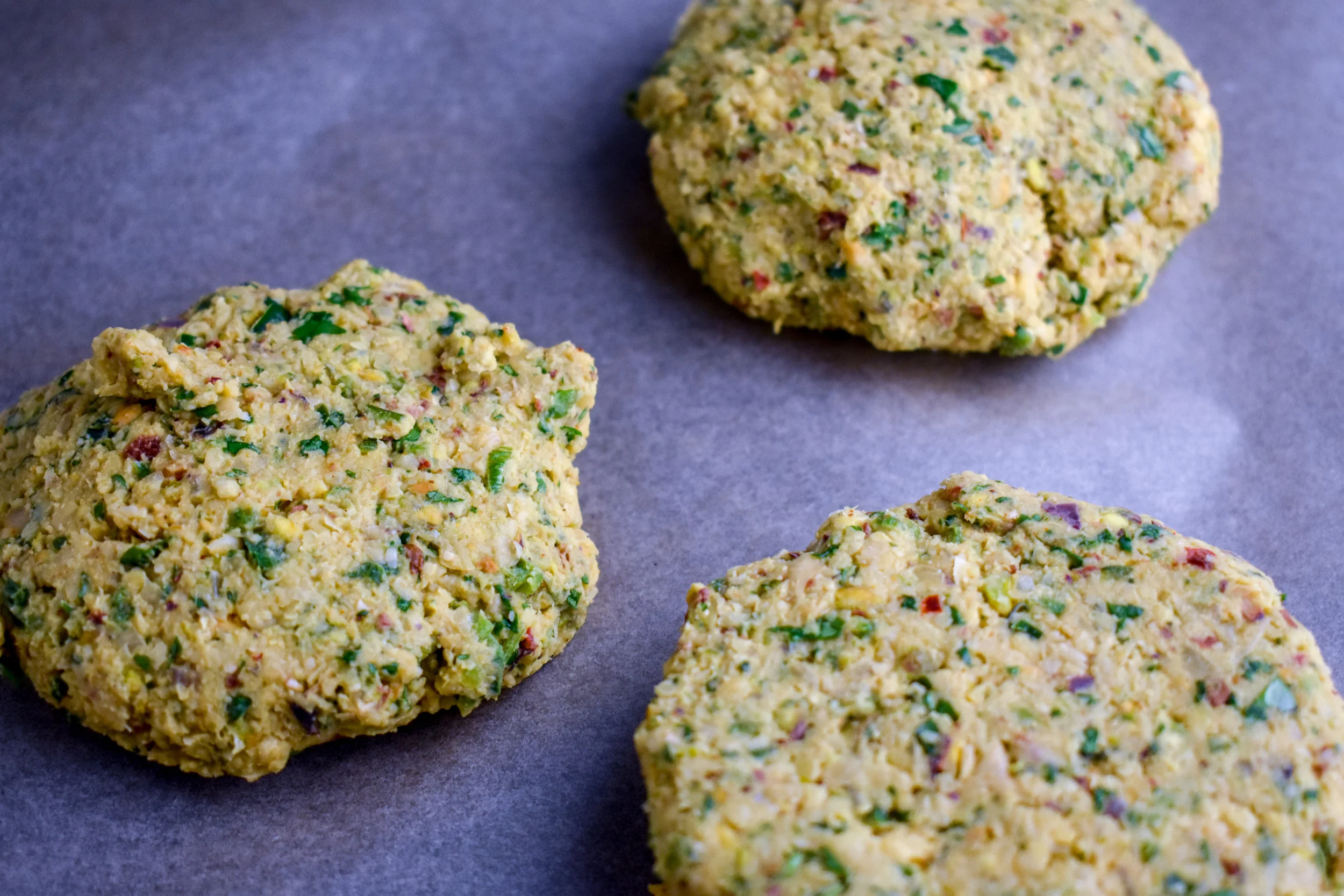 3. Take the mixture and form into four patties. Add 1 tbl of butter to the pan you used to cook the onions. Melt over medium heat and add patties.