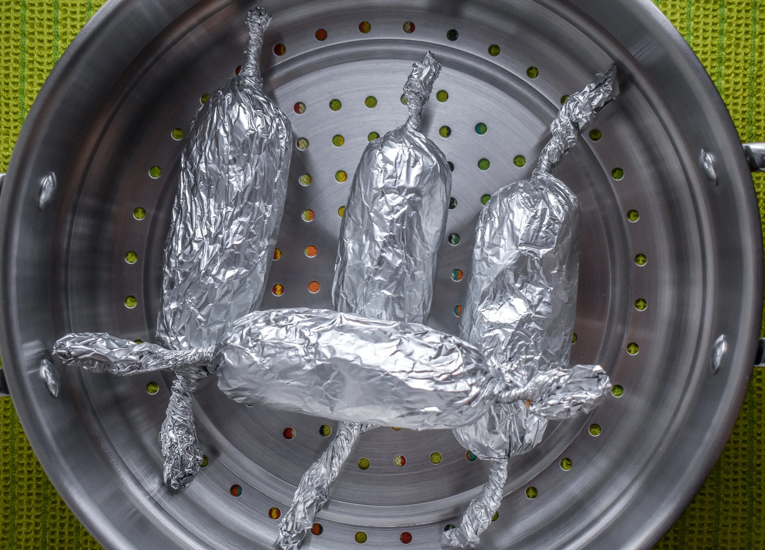 6. Place the dogs in the top part of the steamer pot and place over the boiling water pot. Cover the pot. Steam the dogs for 45 minutes. Make sure you have filled the pot with plenty of water to steam for 45 minutes.