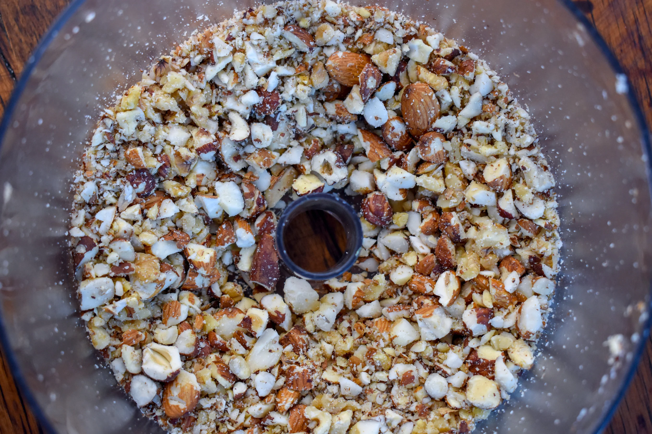 2. Next, Place all nuts in a food processor (or high speed blender) - hazelnuts, brazil nuts, walnuts, and almonds. Pulse 8-10 times. Nuts should be small chunks...not too fine.