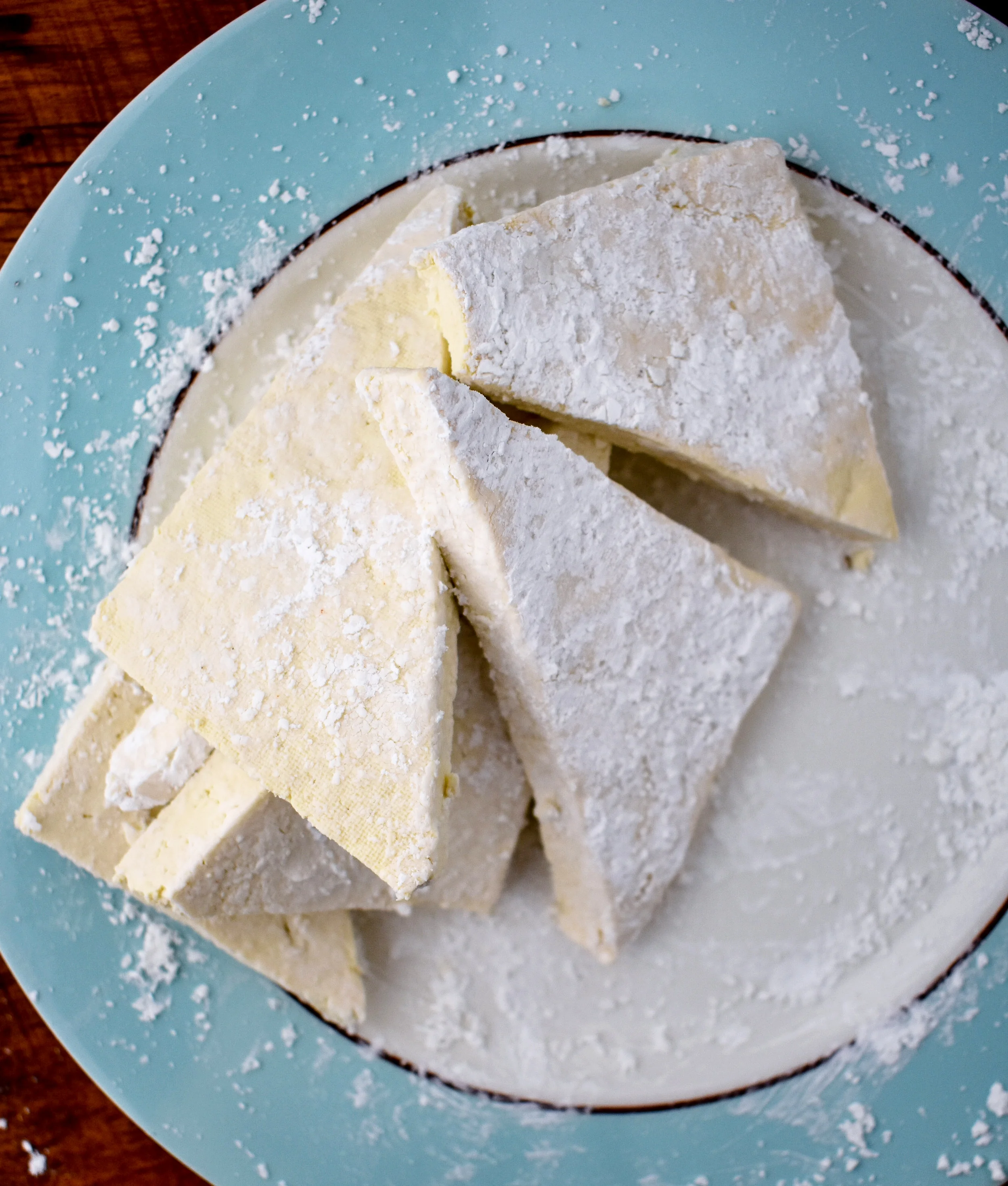 6. While the potatoes bake, slice your tofu half lengthwise and then again across the side to create four pieces. Cut those pieces into two triangles. Take each piece and dredge the tofu in the 1/4 cup cornstarch. You want a nice thin layer on the tofu.