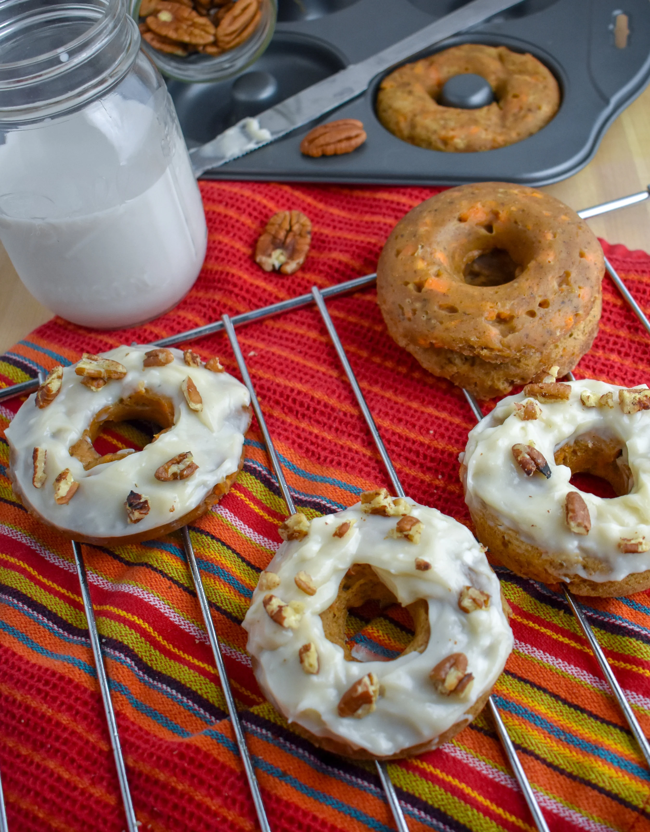 8. While the donuts cool, throw the pecans into a dry pan over medium heat and warm for 5 minutes. Frost the donuts and then sprinkle with the pecans. Enjoy!