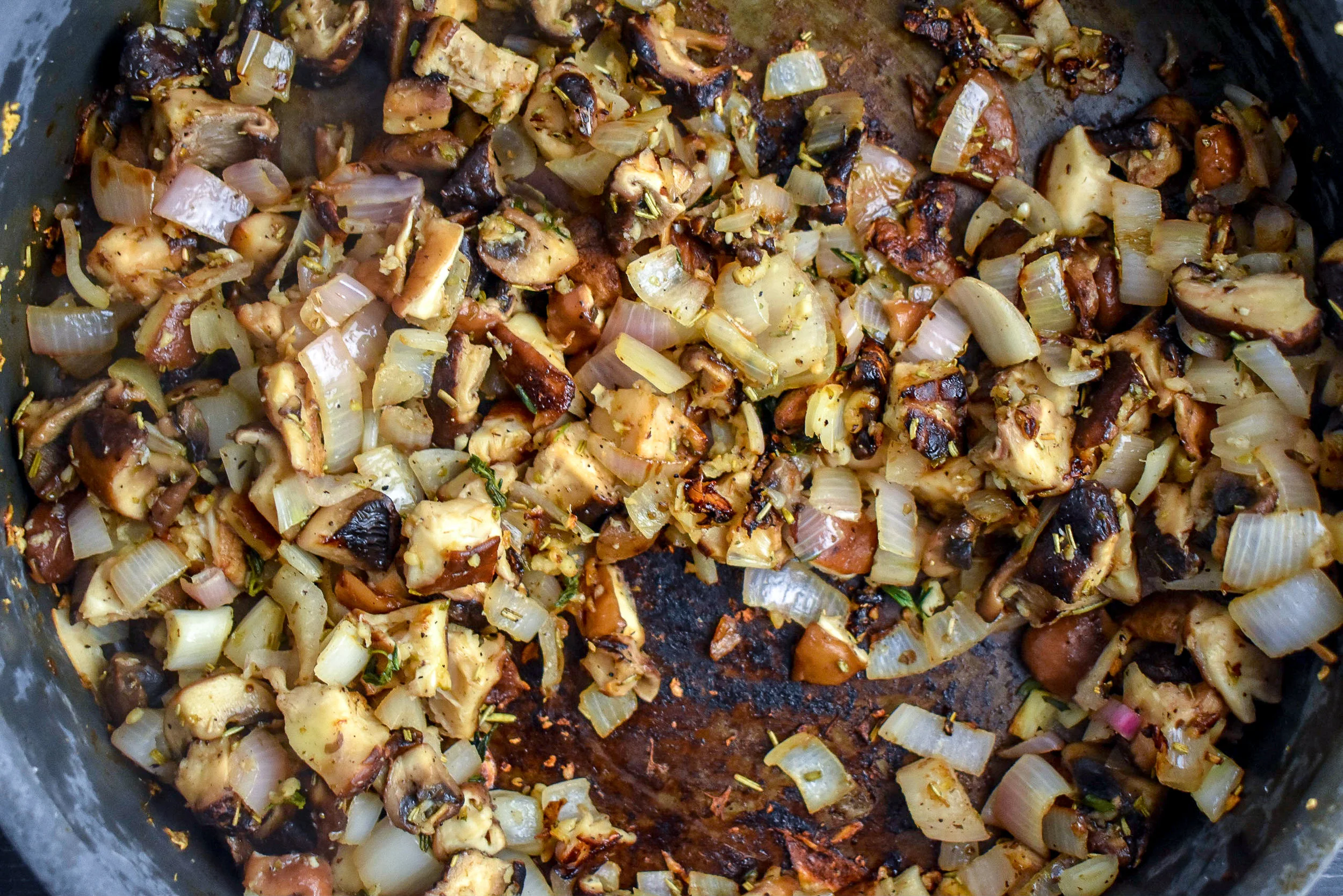 1. Add vegan butter to large frying pan over medium heat. Once melted, add in shallots + garlic, cook for five minutes. Next, add in the chopped mushrooms and cook for another 2-3 minutes until it starts to soften.