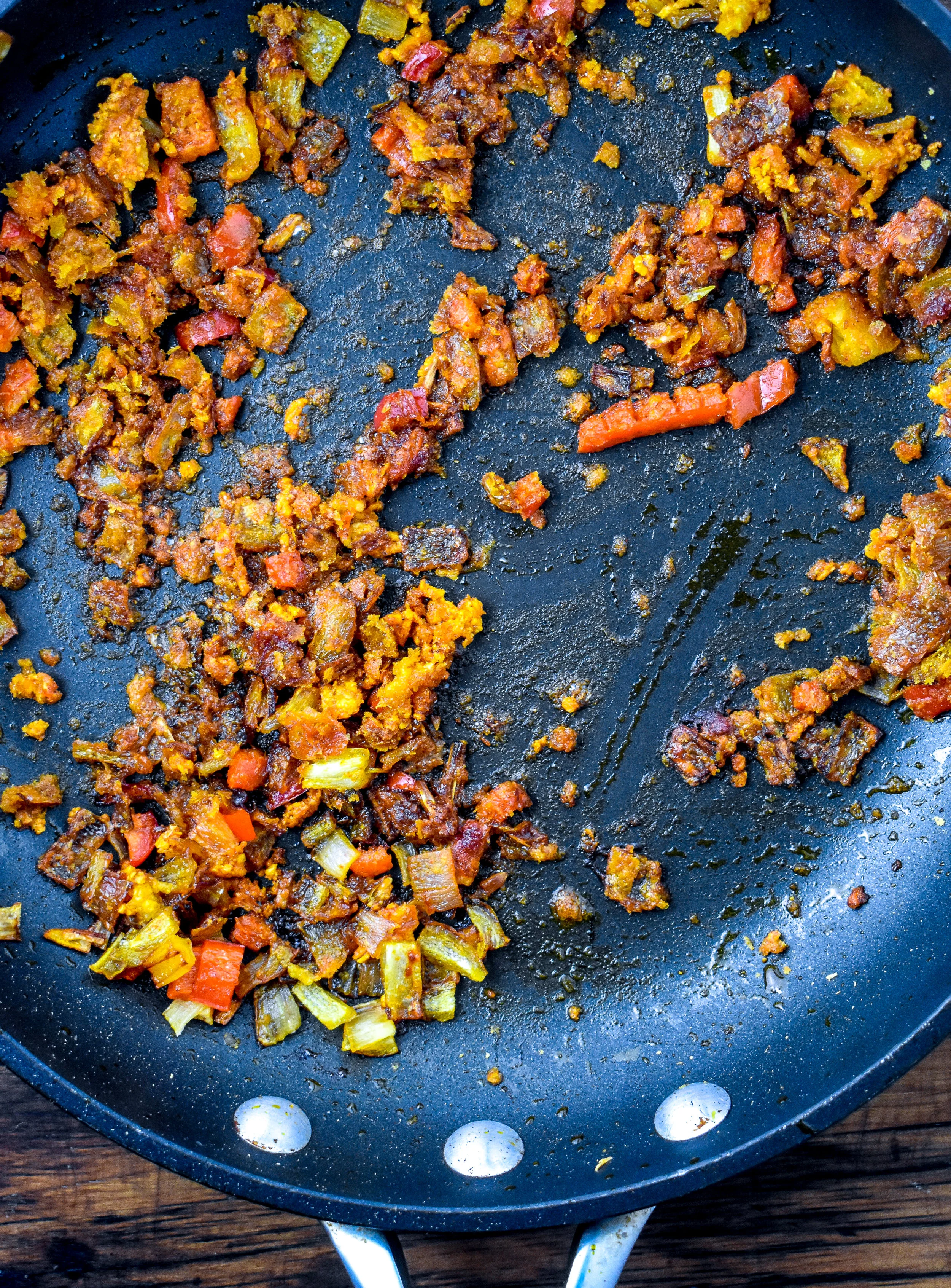 2. Add palm oil to a medium frying pan. Melt and then add shallots, garlic, and jalapeno. Fry it up for 4-5 minutes. Add in spices and mix in for 60 seconds.