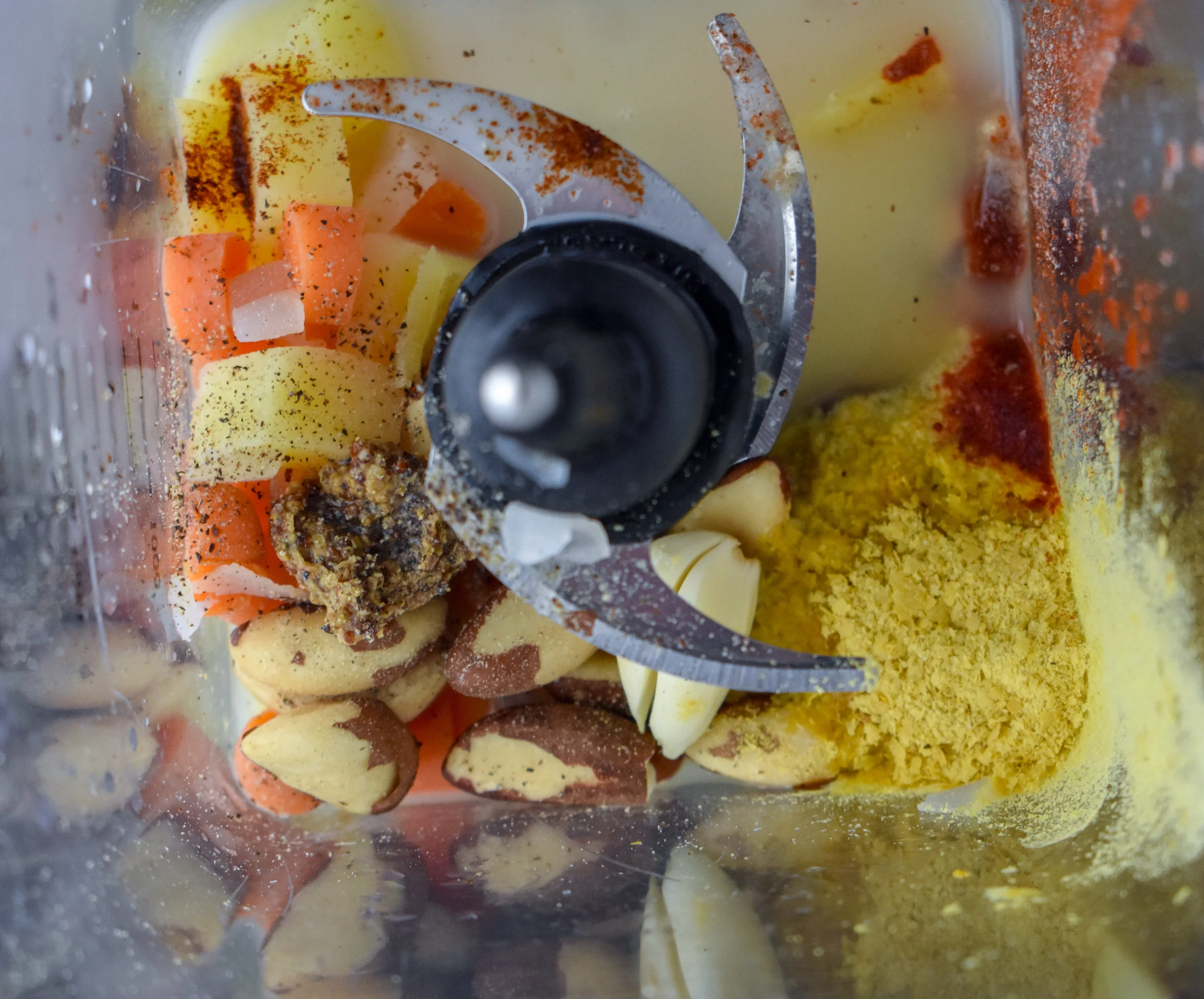3. After you've added the veggies to the blender, add in all the other ingredients from brazil nuts up until wonton wrappers into the blender. Blend on high until the sauce is very well mixed. 