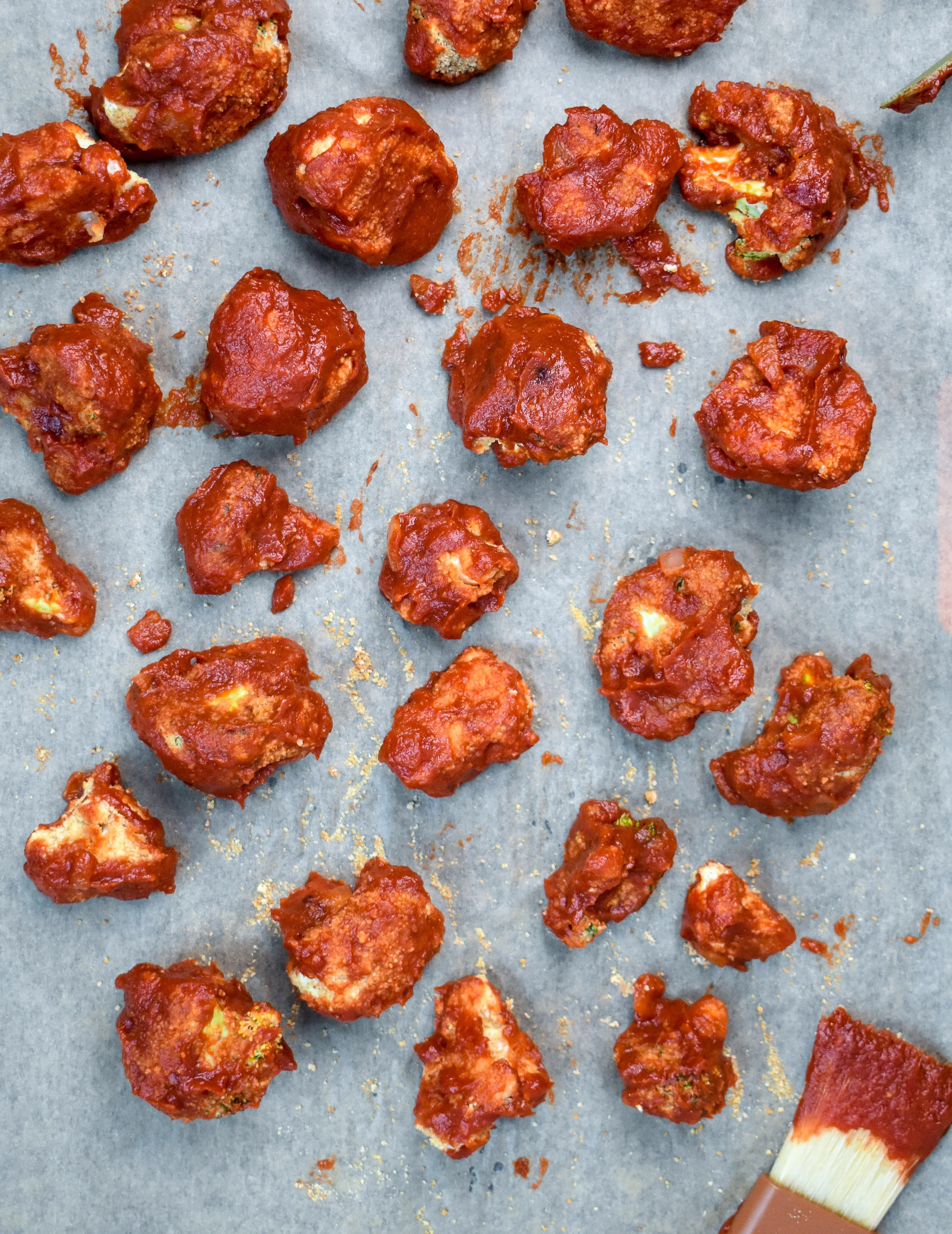9. Once you have pulled the wings out of the oven, coat them with the BBQ sauce. I did this with dunking them into the pan, rolling it around and pulling out. I then used a pastry brush to hit some of the blank spots. Bake again for 7-9 minutes.