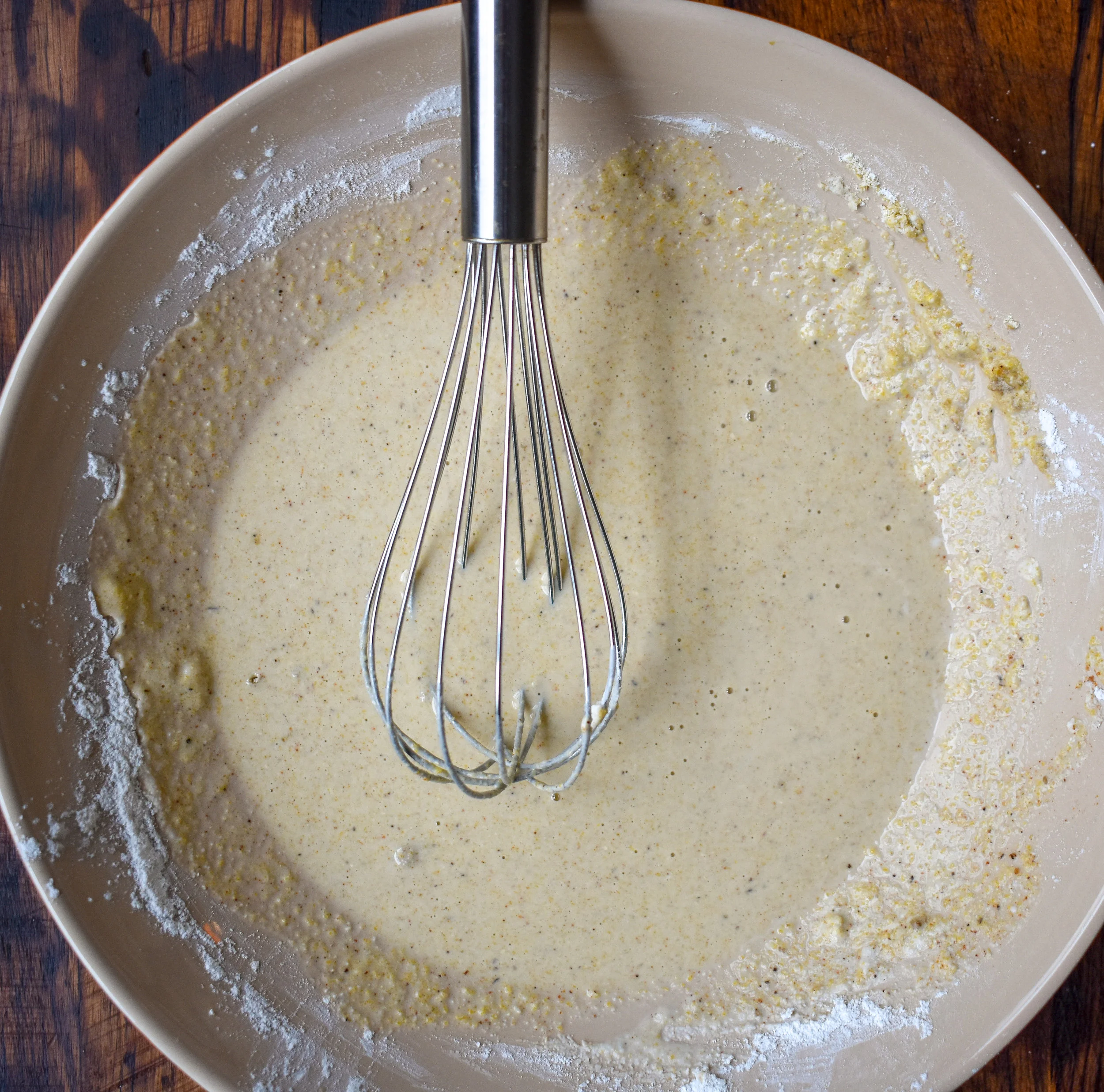 2. Next, mix together the milk, spices, cornmeal, and tapioca flour in a shallow bowl. Add 3/4 cup breadcrumbs to a plate.