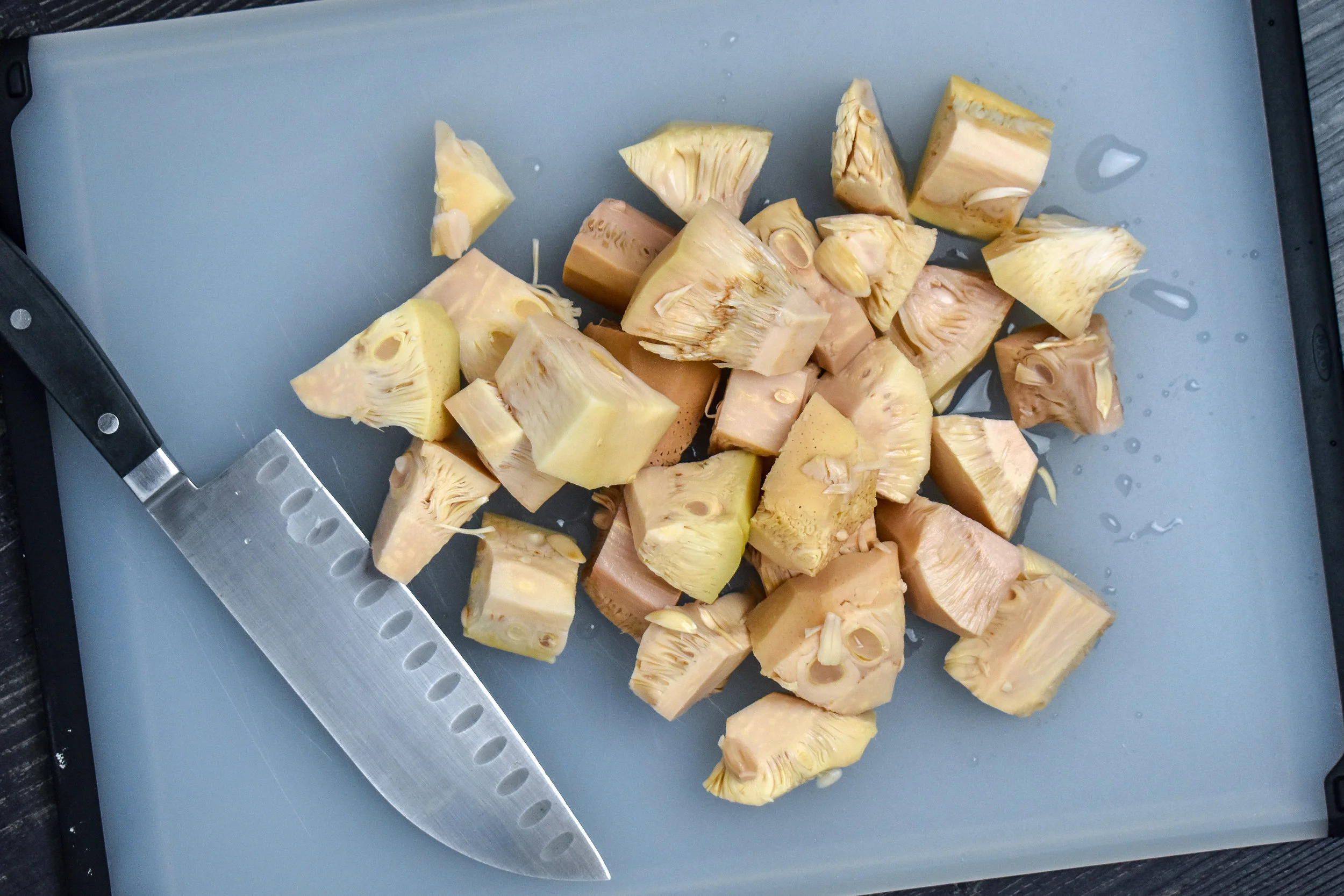 1. Start by chopping your jackfruit into smaller sections, but it can be a rough chop. It breaks down as you cook. Add olive oil, shallots, and garlic to a large frying pan and cook for 4-5 minutes over medium heat until starting to become translucent.