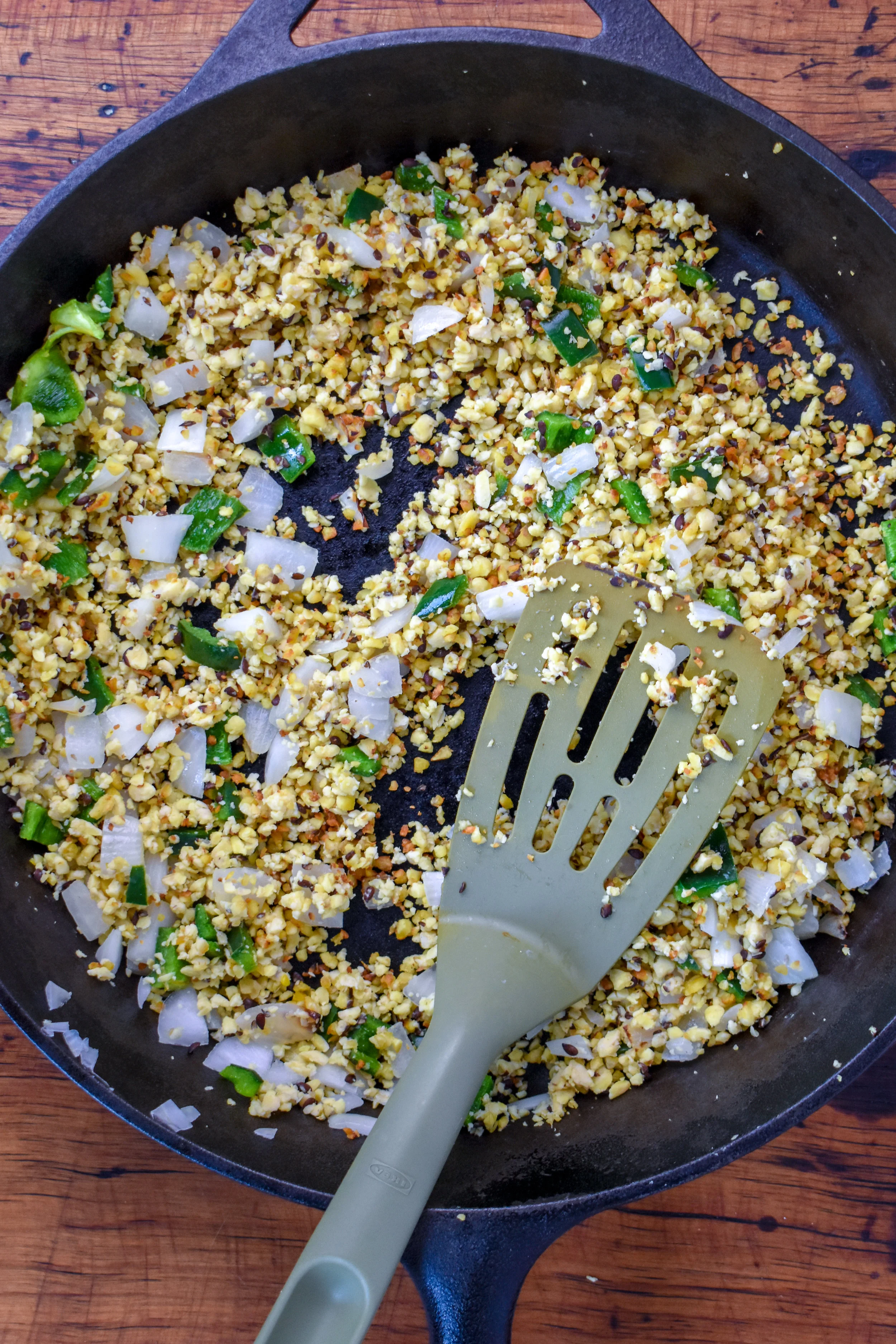 2. For the chili, add oil, processed tempeh, onion, and poblano pepper to a castiron/frying pan. Cook for 7-8 minutes over medium heat.
