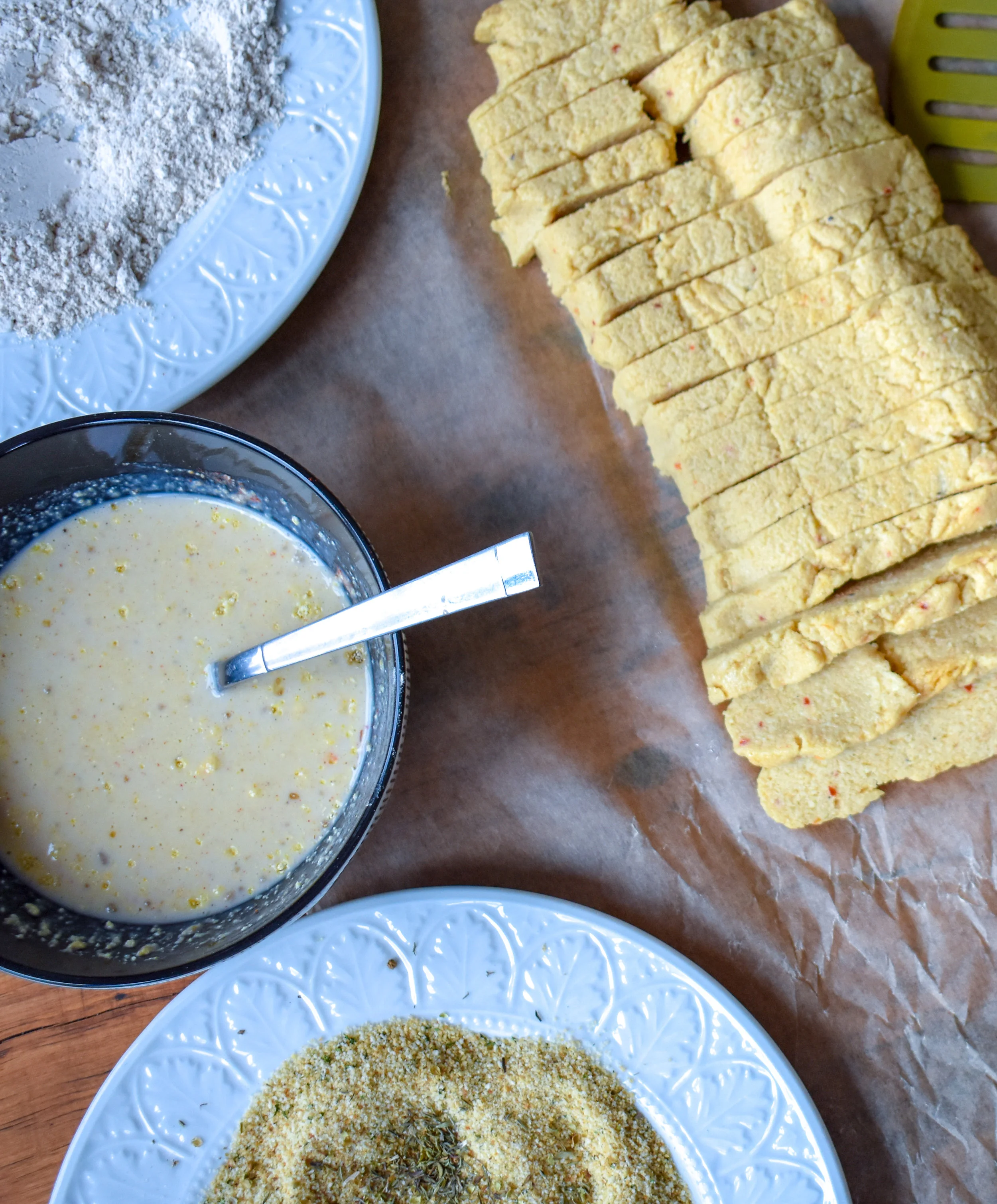 5. While the cheese is setting, set up your breading stations. We want three - one with flour, one with the milk bath (whisk together ingredients), breadcrumbs and spices.