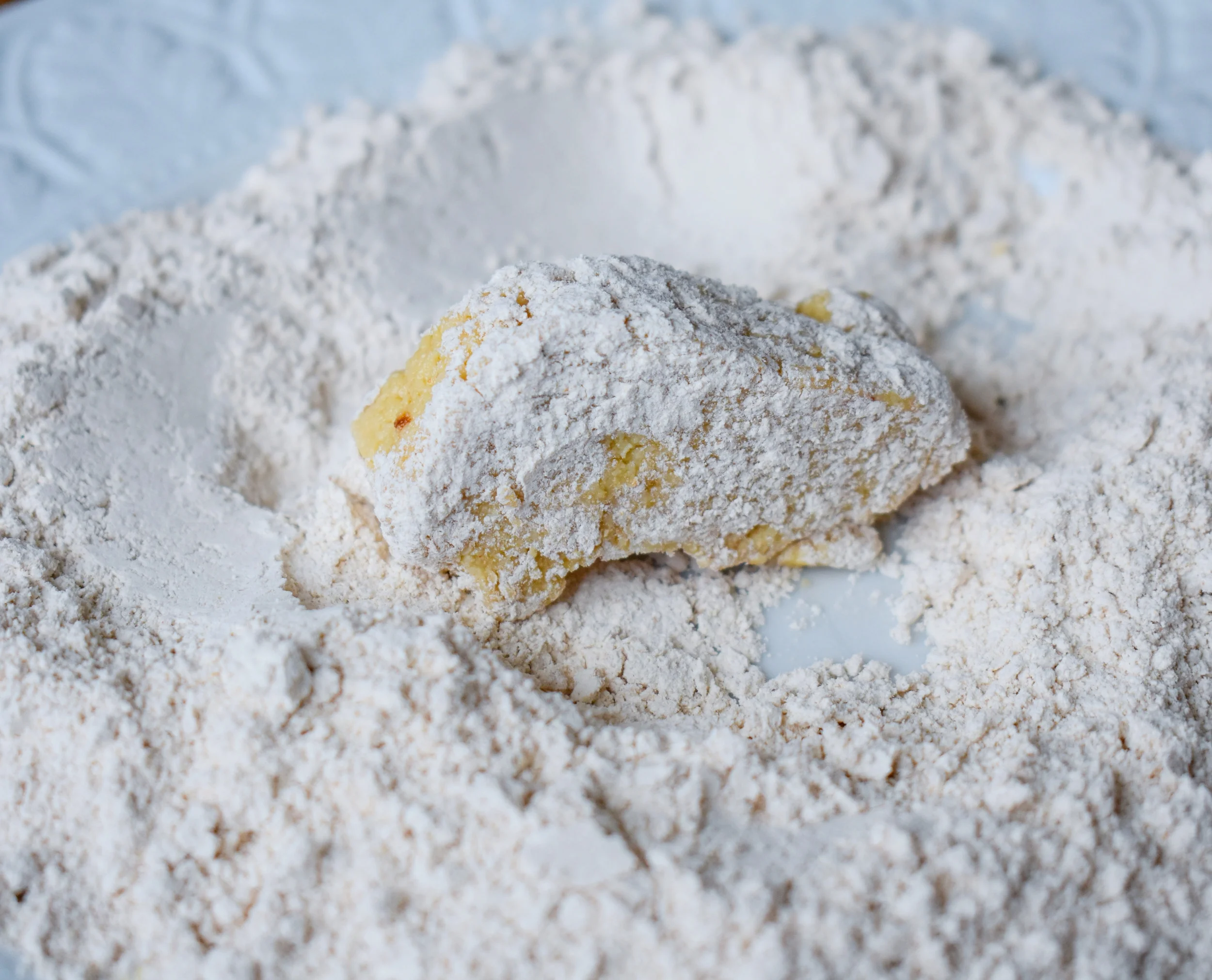 7. To bread, first place sticks into flour quickly to coat. 