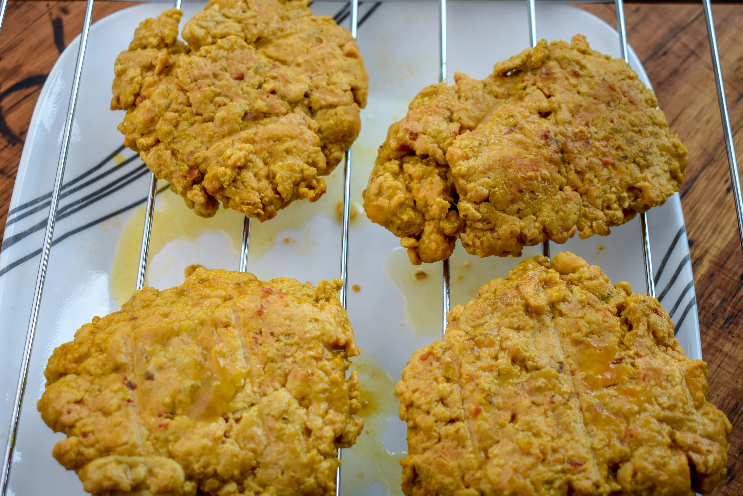 3. Once the broth is boiling, add all four patties to the pot. The patties should be completely covered. Cover the pot + reduce to medium-to-medium low heat and boil for 50 minutes. Place on a drying rack or plate once done.