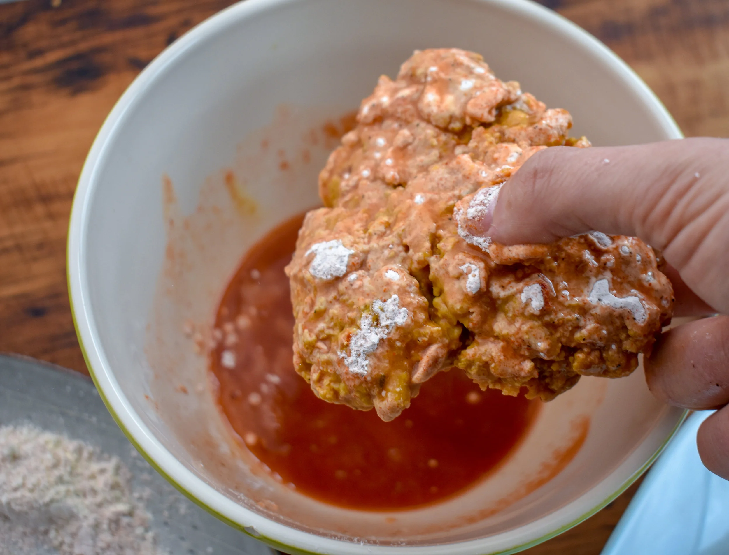 6. Next dredge the patty in the pepper sauce and then coat again in the flour. Repeat for all four patties. Add 2 tbl of vegan butter to the pan. Once its popping add the patties.