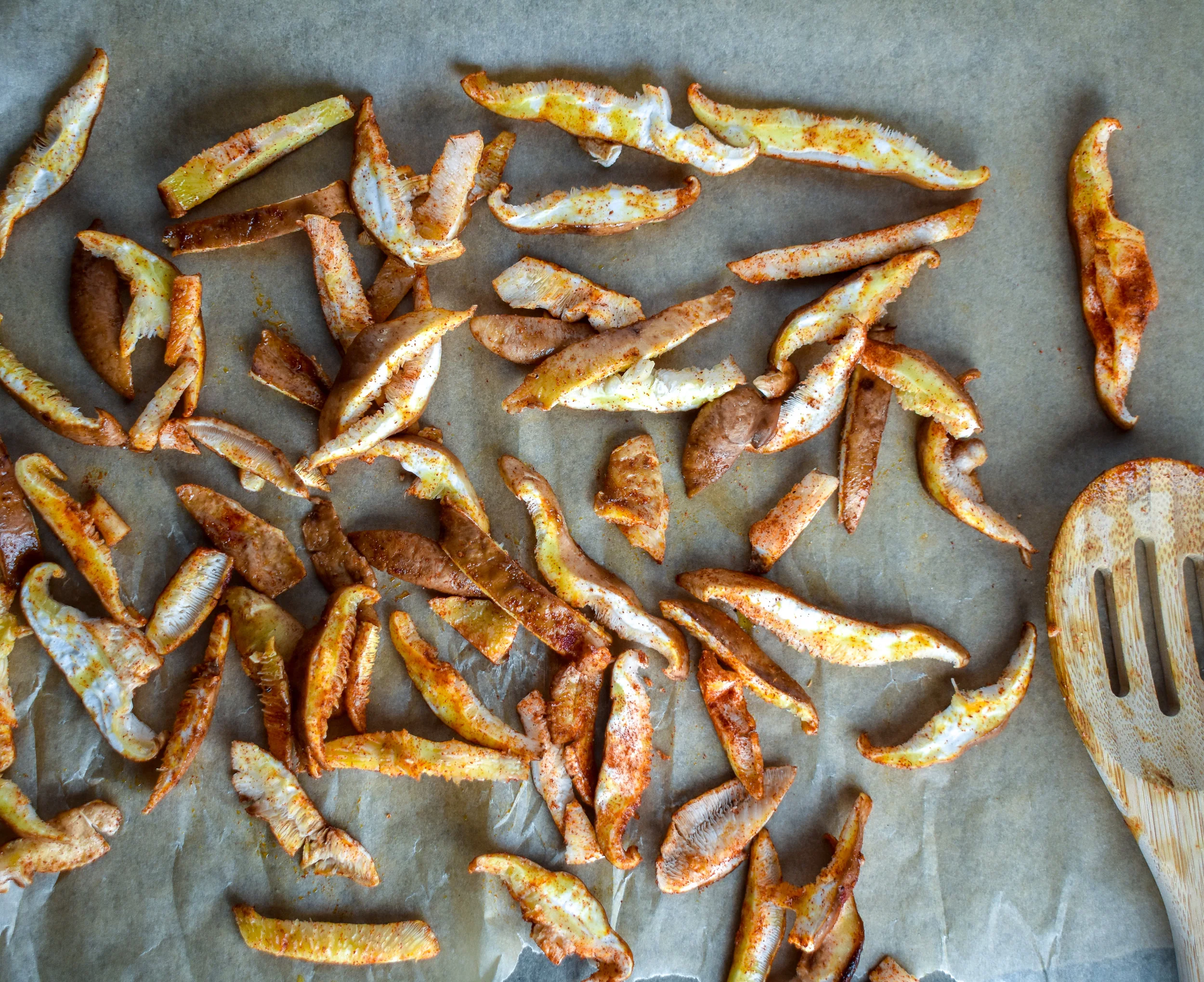 2. Mix the mushroom slices with olive oil + spices. Place onto a parchment-lined bakings sheet and bake for 20-22 minutes at 400F.