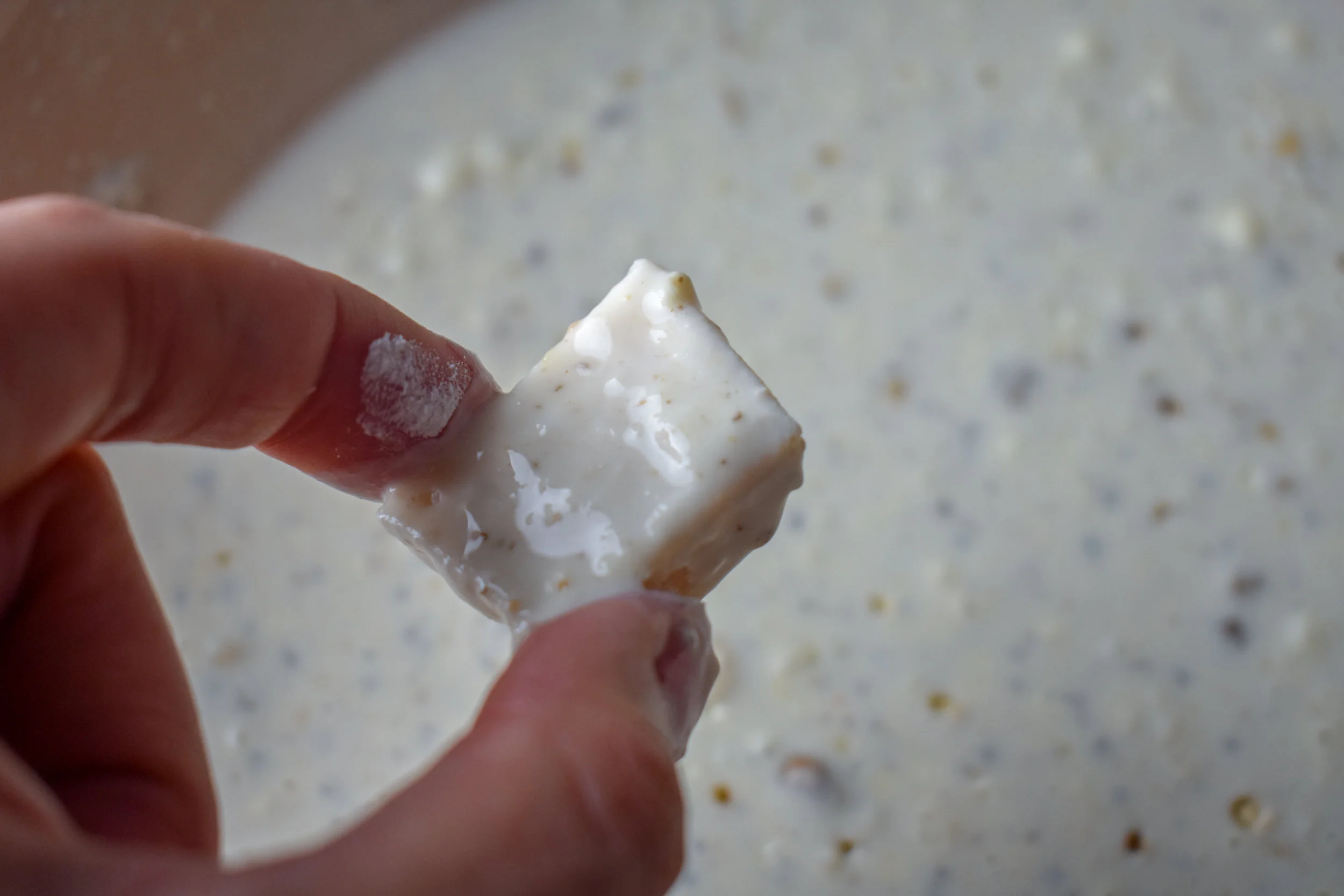 5. Next, bread + batter the mushrooms. Start by dunking into bowl 1 with the rice flour. Coat then dunk into the milk bath. Dunk it in and let it coat. Then pull it out and let the excess drop off.