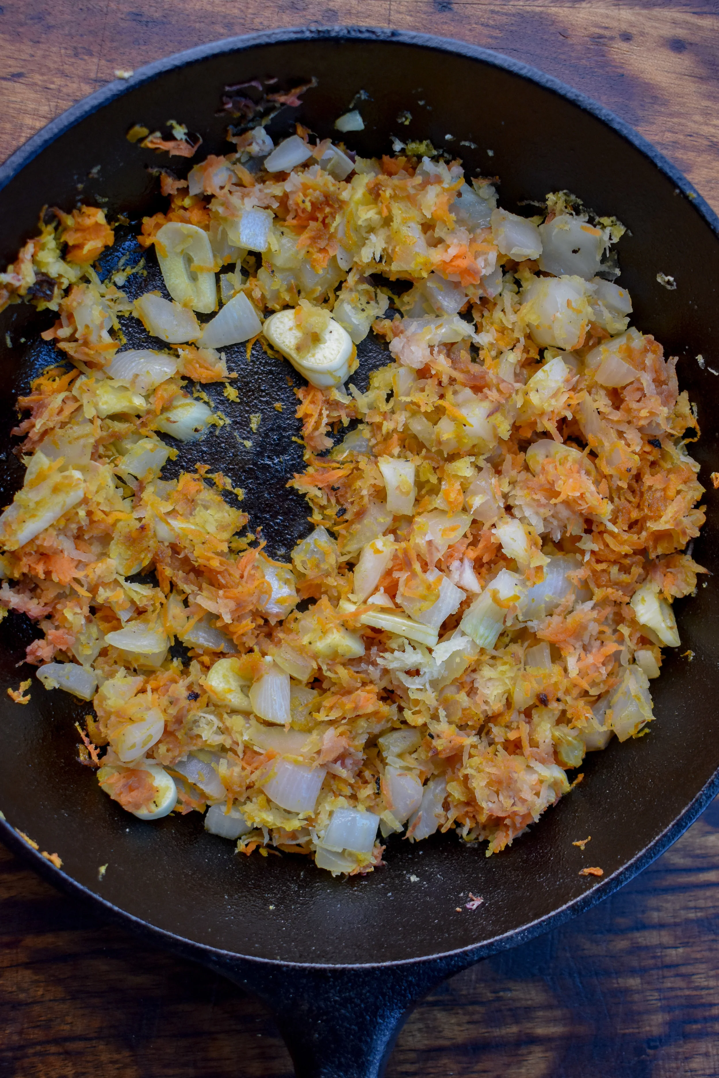 2. While the rice cooks, add olive oil for burgers to a medium frying pan on medium heat. After 30 seconds, add shallots, carrots, and garlic. Cook for 5-6 minutes.