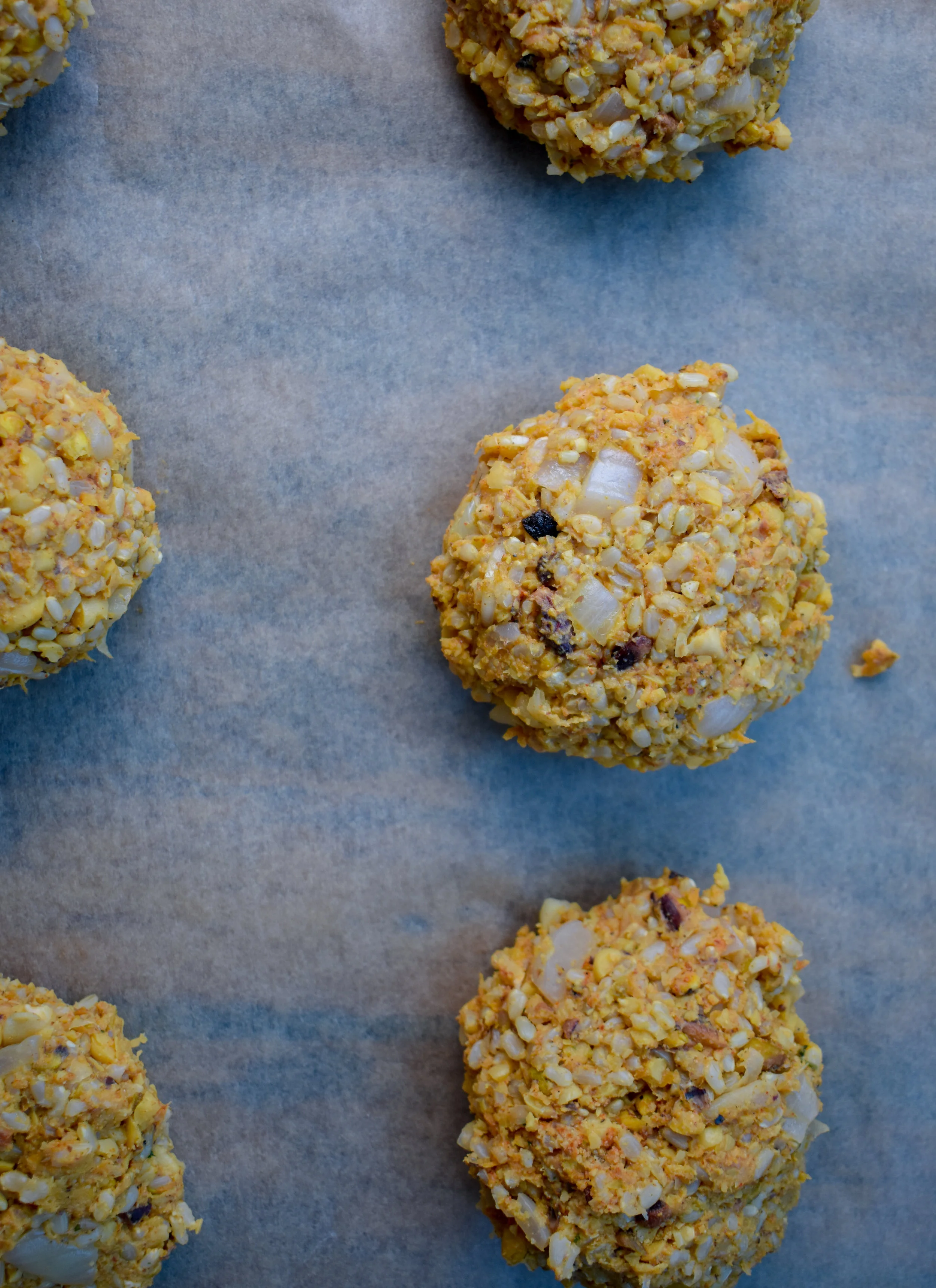 9. Once the rice is done, add to the mixing bowl with the pulsed mixture and carrot/shallot/garlic mixture. Add in the brown rice flour and breadcrumbs. Mix it up with your hands until well combined. Form into 4-6 extra large patties with your hands. Set on a plate.