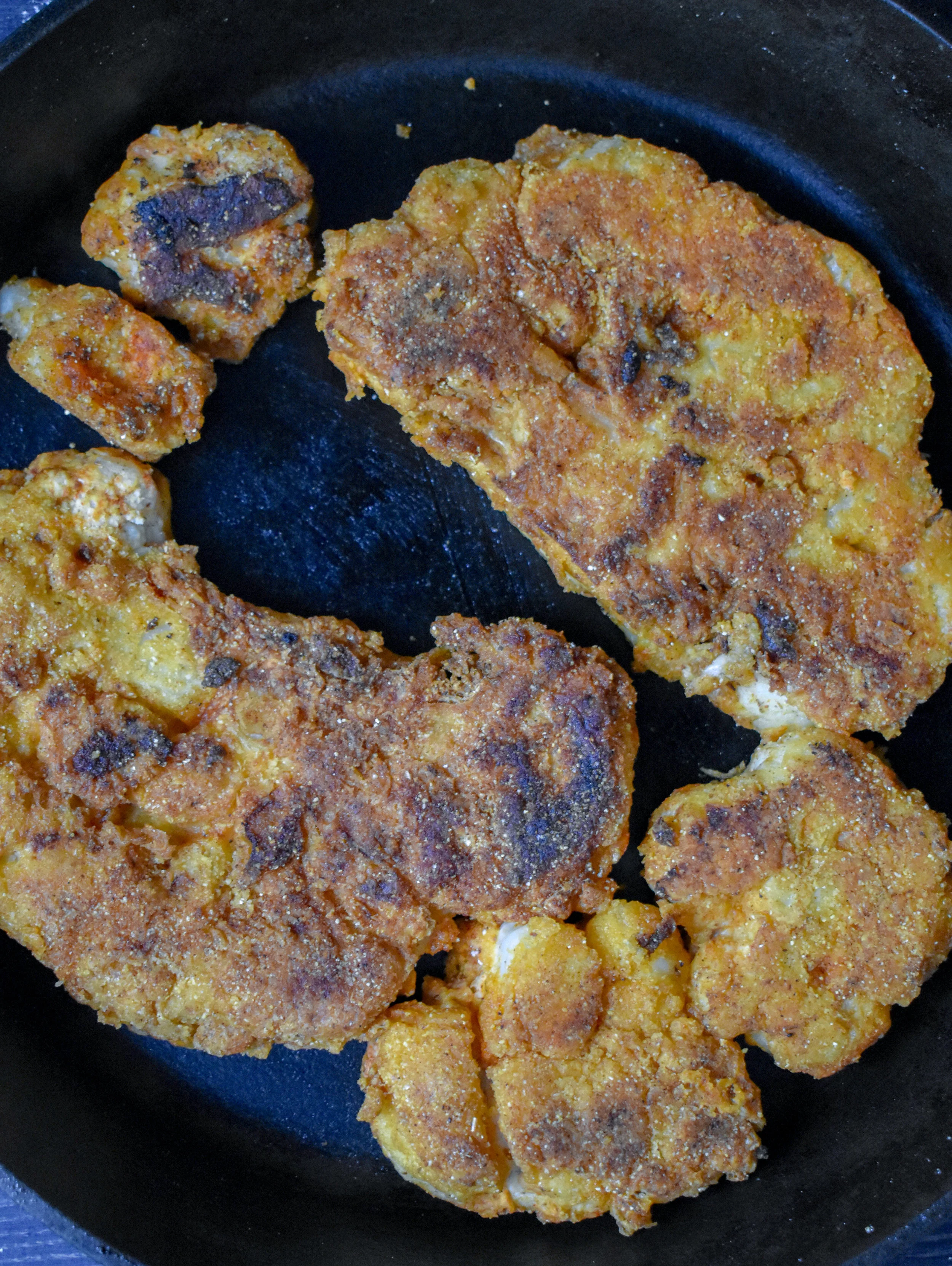 5. Finally, place the cauliflower in the last breading station. Coat it well. I use my hand to scoop it and dump over top. Place on a plate. Add 1/4 cup of butter to a cast iron pan and once it begins to pop on medium-high heat add the cauliflower. Cook for 4-5 minutes on the first side then 3-4 on the next.