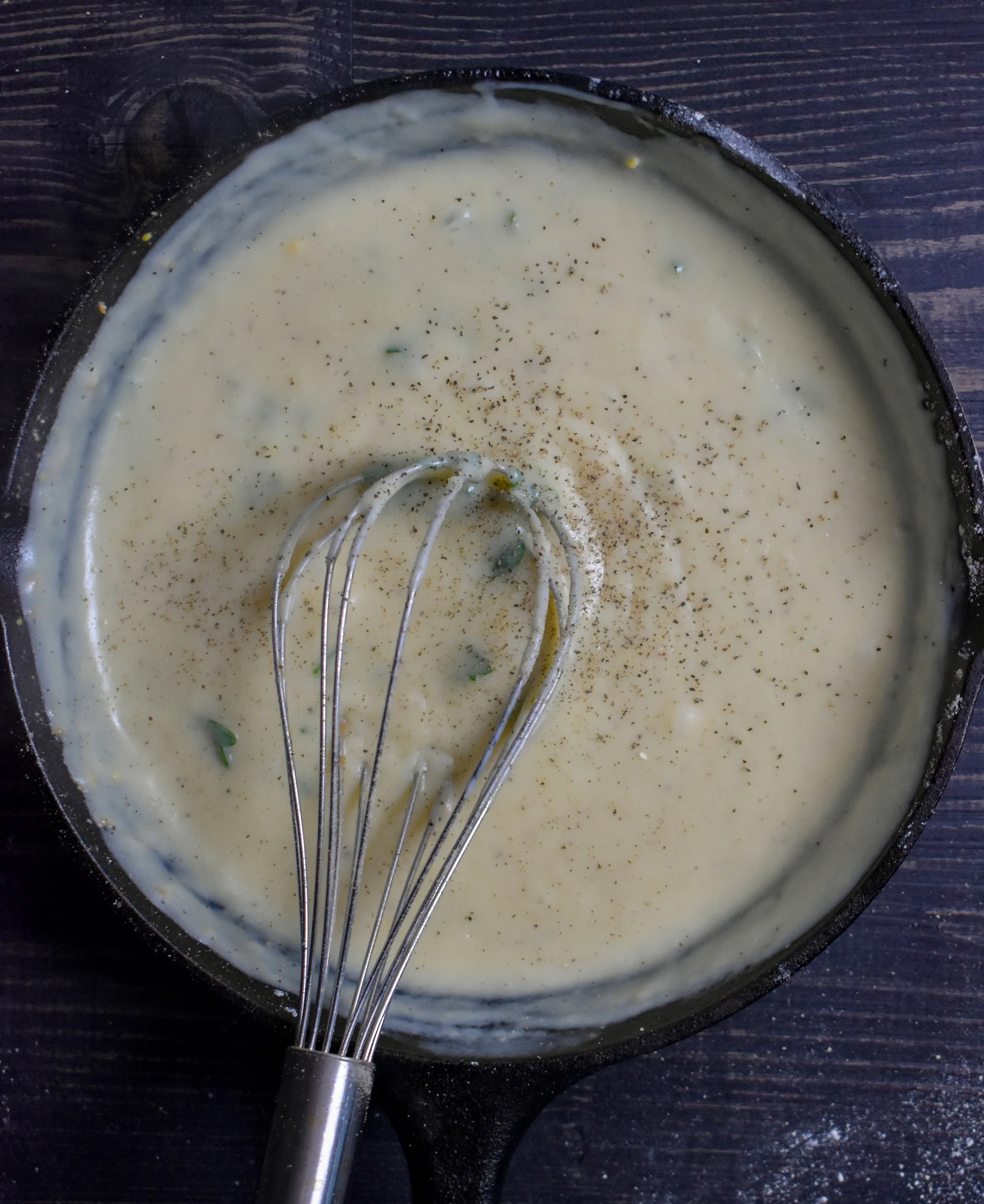 6. While the cauliflower is cooking, let's make the gravy! Add butter to a smaller pan and as it melts add in the flour. Once its whisked together, pour in the milk and rest of ingredients while whisking. Continue to whisk for 2-3 minutes until it begins to thicken. Let that cook for another 2-3 minutes, whisk again to mix well and its ready to serve.