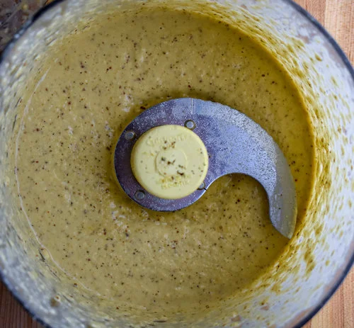 5. While the patties are in the freezer, blend together all the caesar dressing ingredients in a food processor and mix together the salad parts in a large serving bowl or 4 smaller serving bowls.