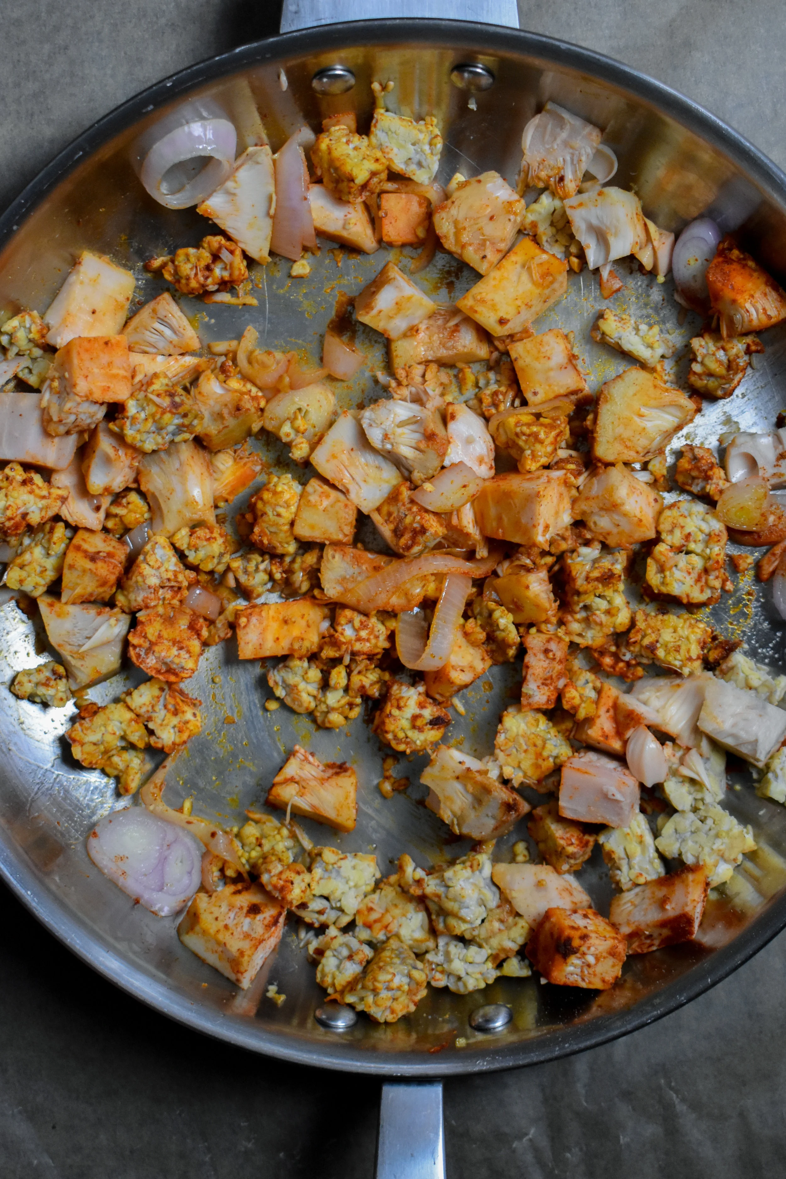 5. Add the shallots and garlic for jackfruit/tempeh to a large frying pan with 1 tbl coconut oil. Mix and cook for 4-5 minutes over medium heat. Next, add jackfruit and tempeh to the pan and cook for 1-2 minutes. Mix in the bbq sauce, cover, and cook over medium-low heat for 15 minutes.