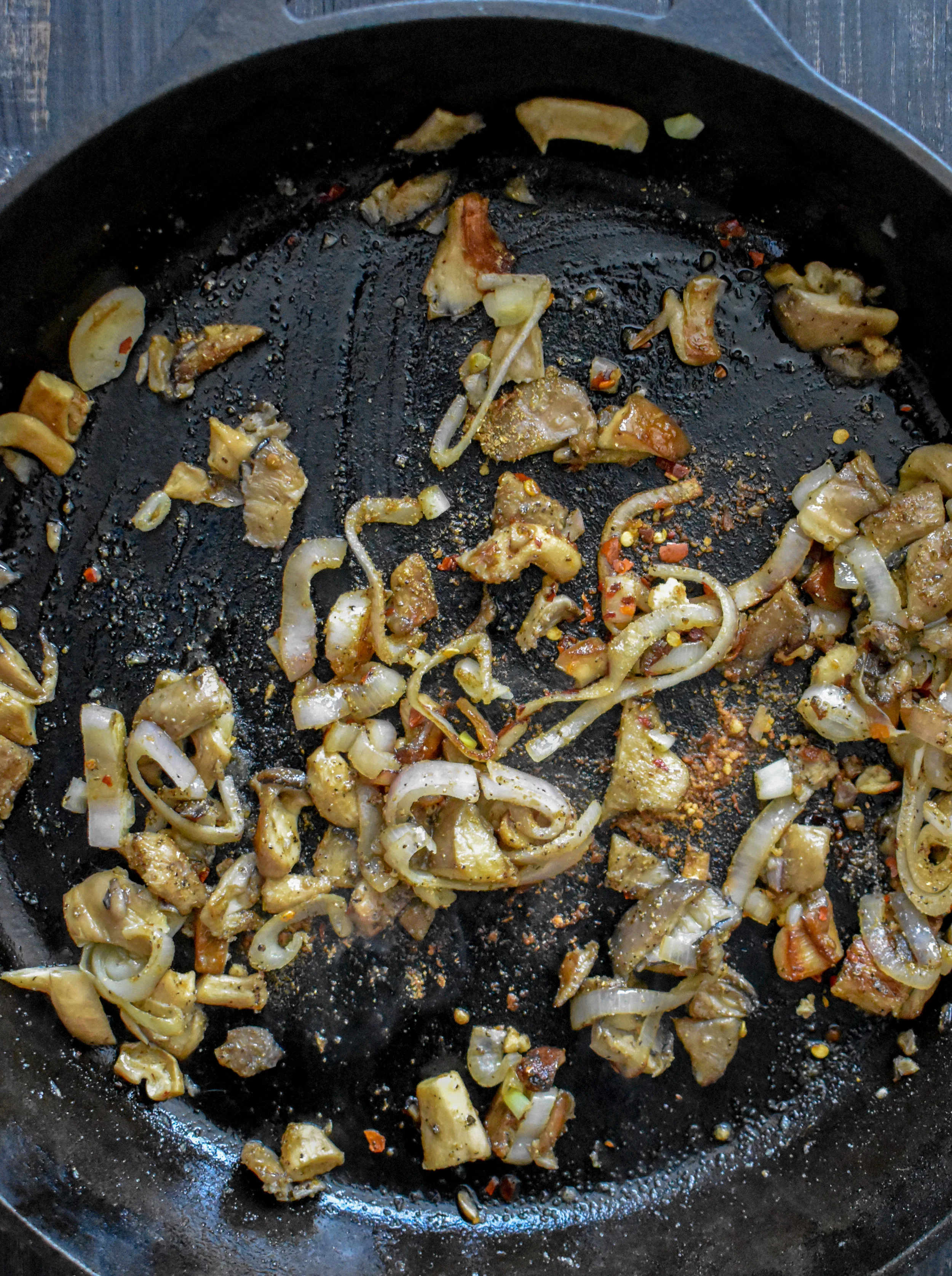 7. While the biscuits are cooking, place oil, shallots, and mushrooms in a pan. Cook over medium heat for 8-10 minutes until the mushrooms start to soften. Add spices and cook for another 60 seconds before adding flour for gravy.