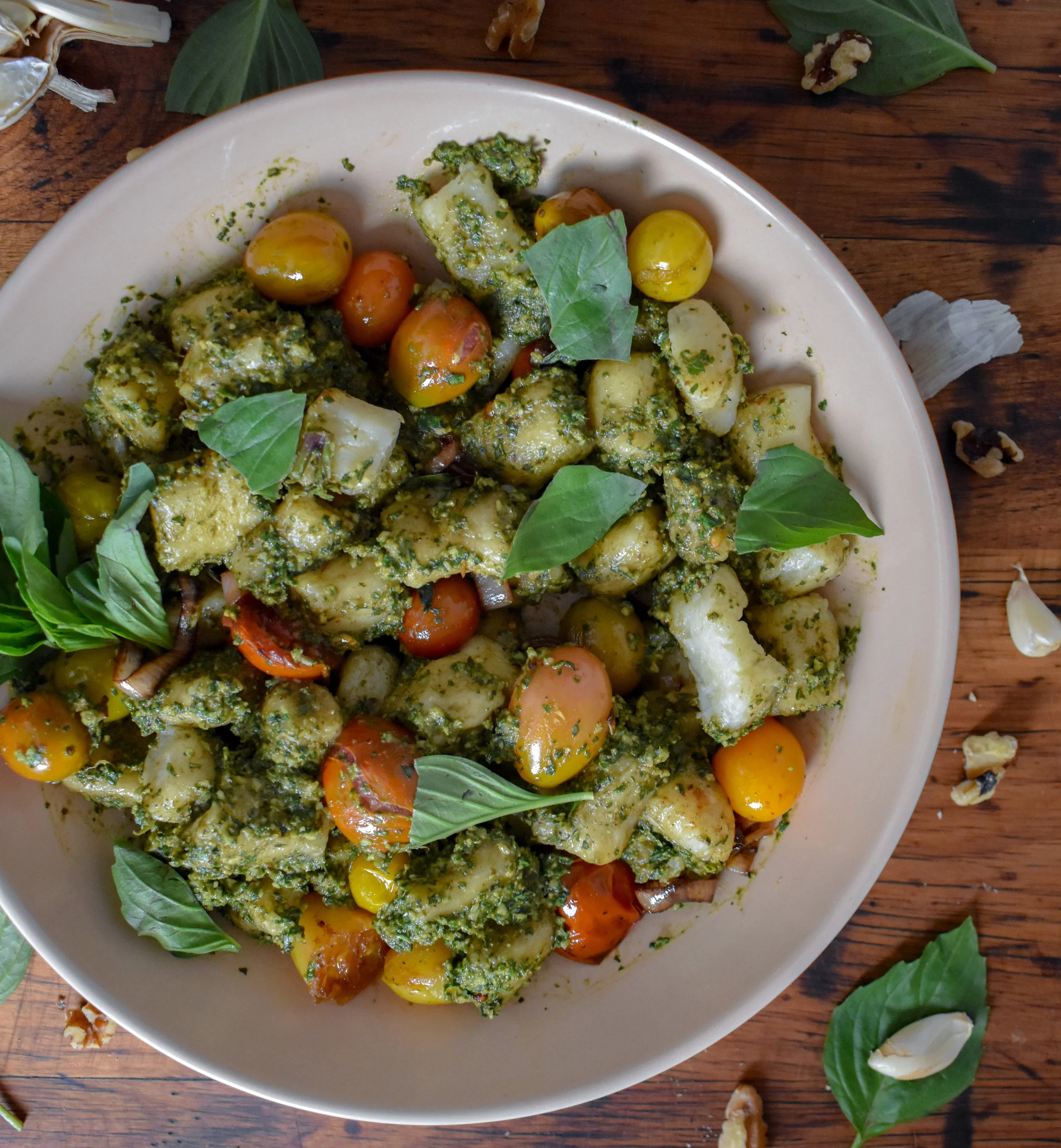 8. Mix the pesto and blistered tomatoes in with your gnocchi. Transfer to a serving dish (if you fancy) or just serve in the mixing bowl. Add a bit of fresh basil and dig in. Enjoy!