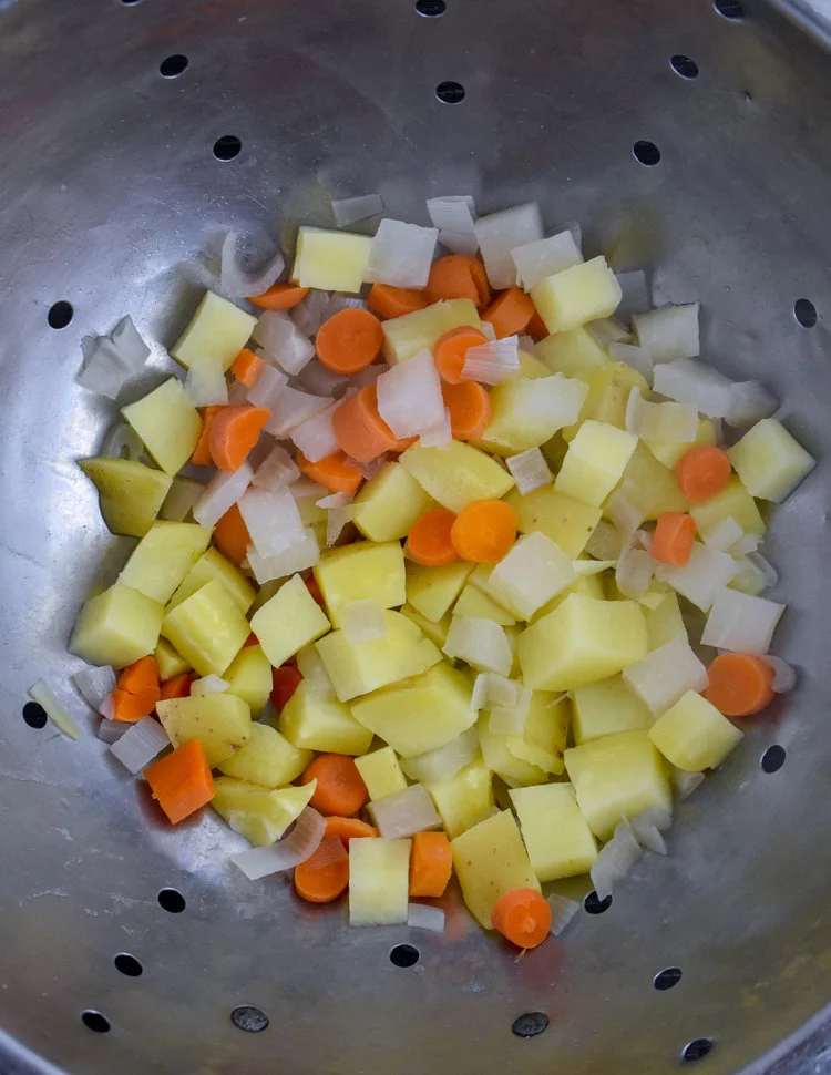 5. Bring 6 cups of water to a boil and add potatoes / carrots / onion to the boiling water. Boil for 