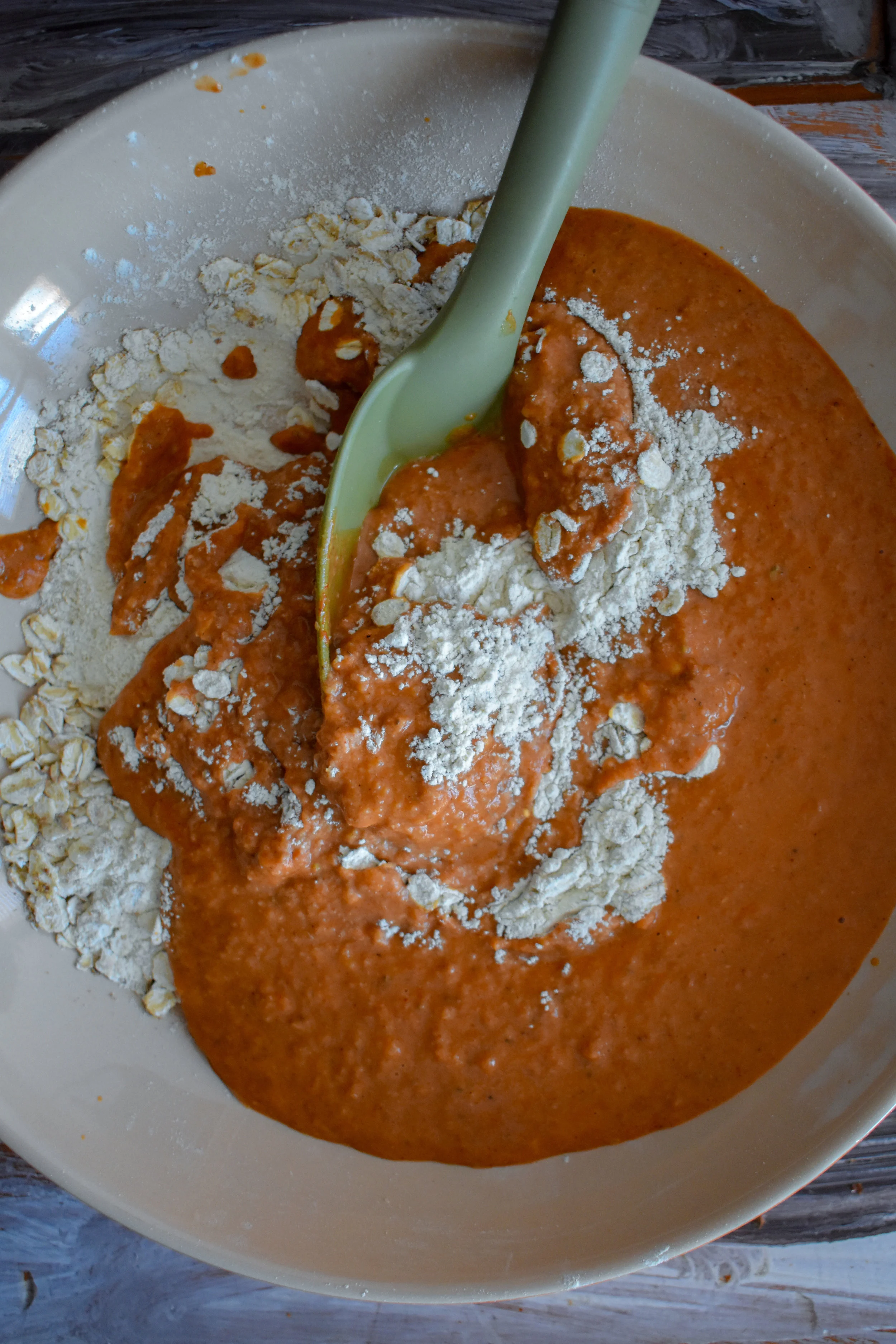4. Next, pour the blended sauce over the dry ingredients and slowly mix with a mixing spoon (wooden). The formation should be very wet and sticky.