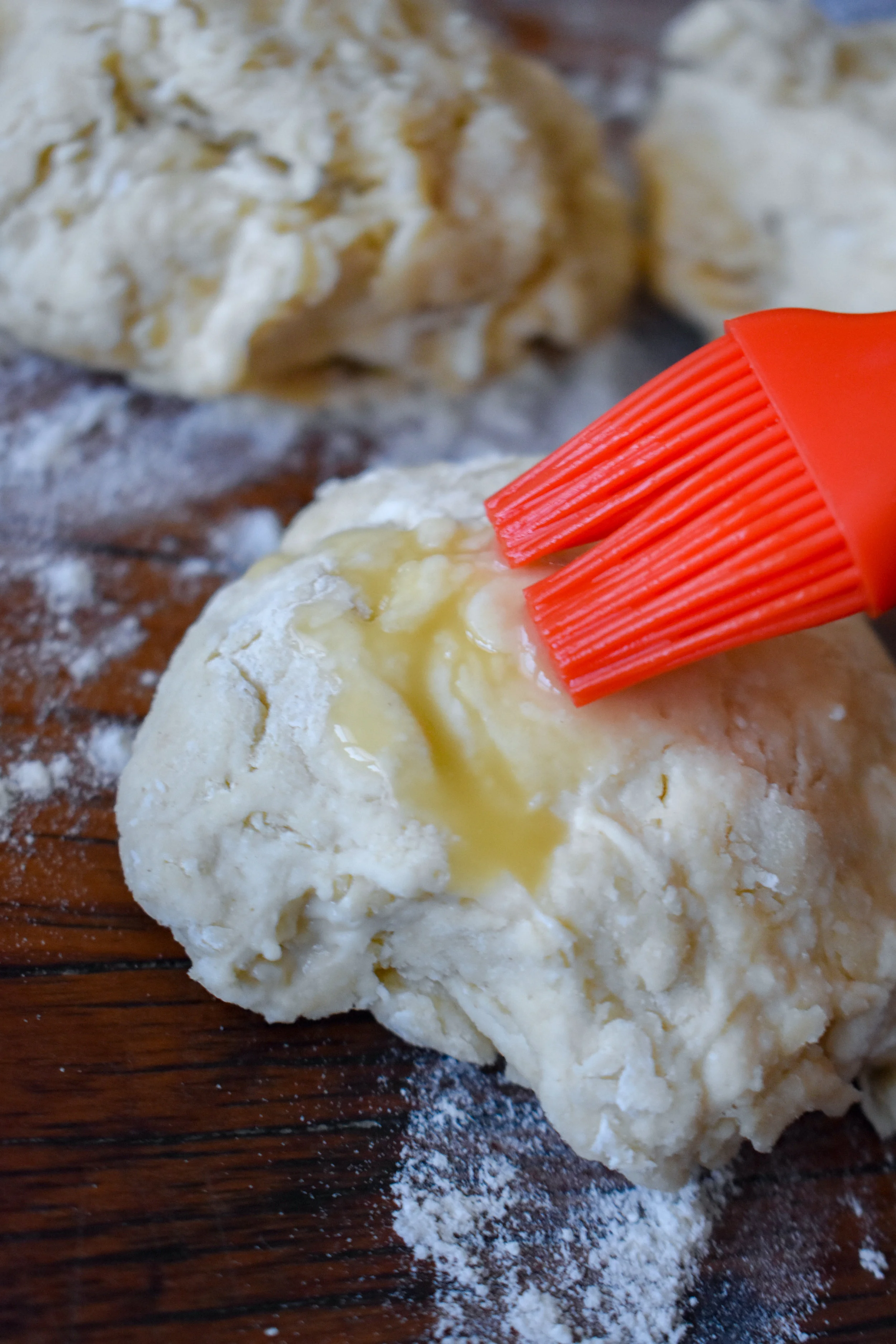 8. Using your melted butter + a pastry brush, coat the top of your biscuits with the melted butter.