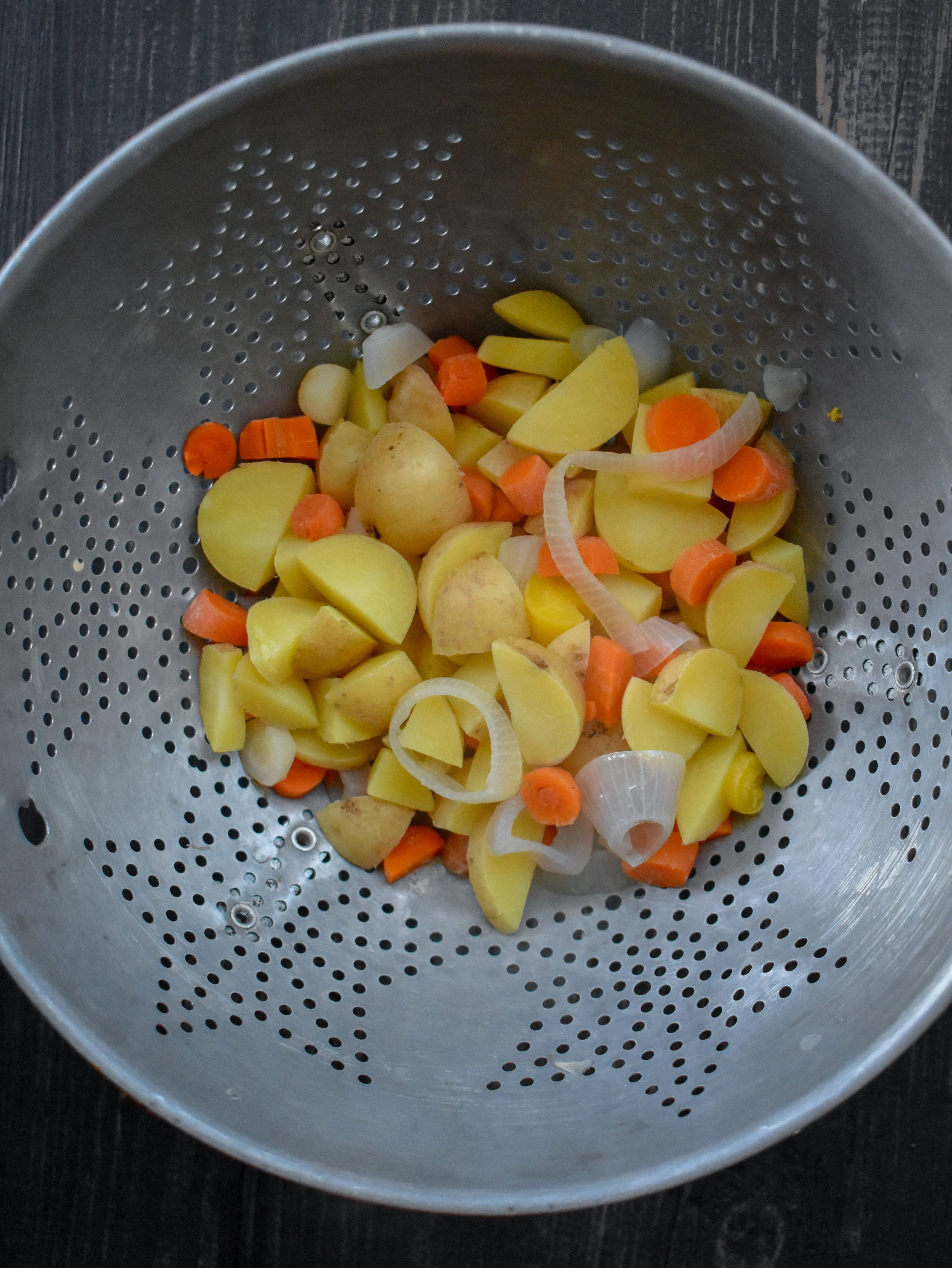 1. Place potatoes, carrots, and shallots into pot of 6 cups of boiling water. Boil for 10 minutes then drain and add to a food processor.