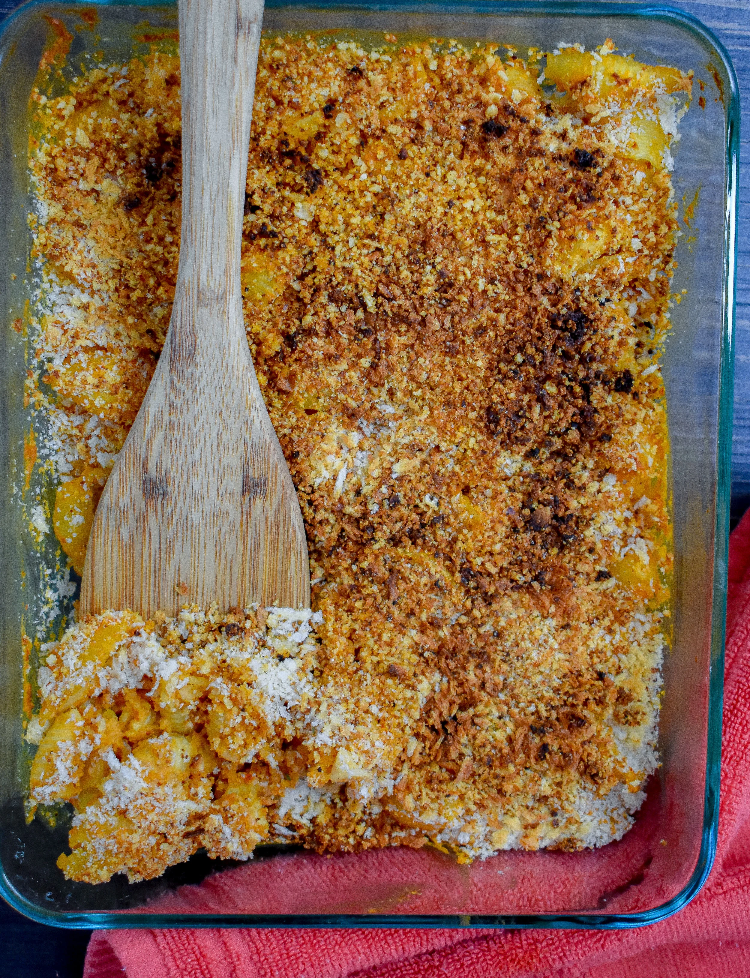 6. Add cheese blend + panko breadcrumbs to the top of the mac + cheese casserole and place into oven. Bake at 400F for 16-20 minutes then broil at 500F for 4-5 minutes until breadcrumbs/cheese blend start to brown.