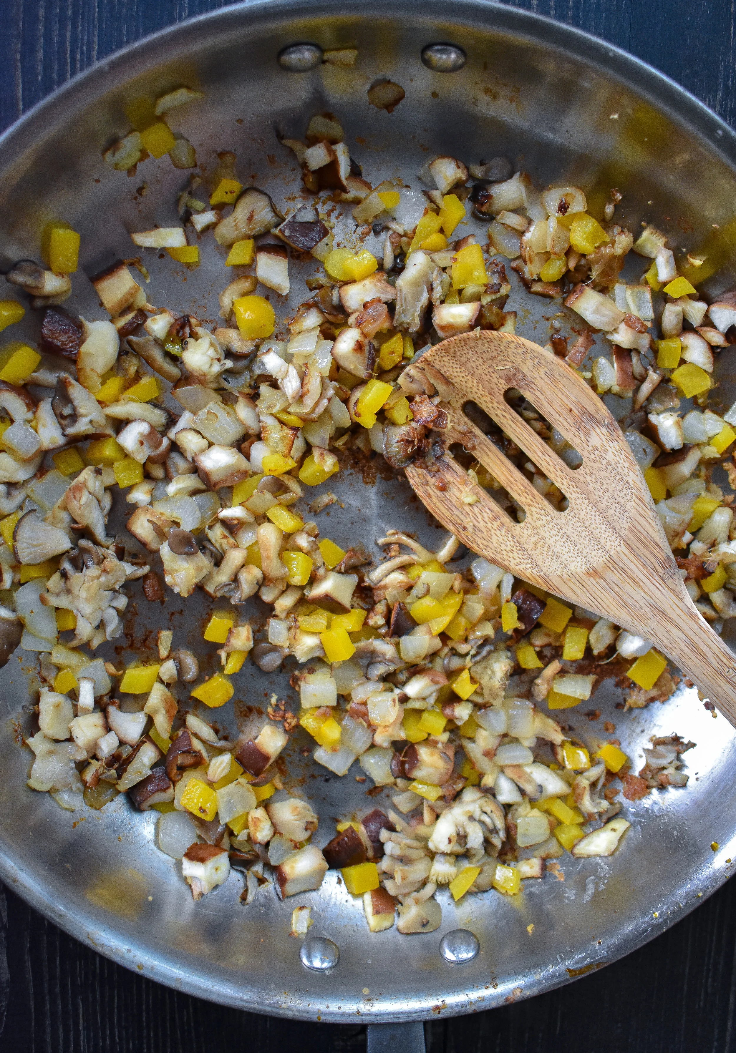 1. To start, add 2 tsp sesame oil + butter for the filling to a large frying pan (could use a wok on medium low heat) over medium heat. Heat for 60 seconds. Add onion, garlic, and ginger. Cook for 4 minutes. Add mushrooms, peppers, salt, pepper, and fennel. Cook for another 3-4 minutes until mushrooms start to soften.